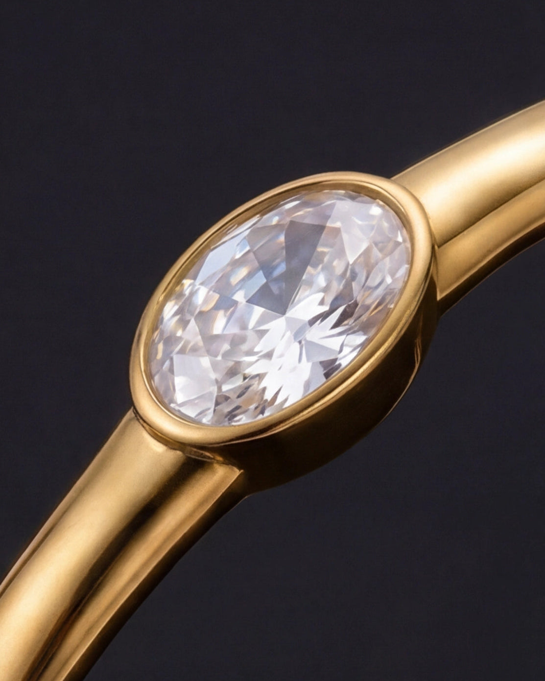 Gold ring with a large diamond on a black background