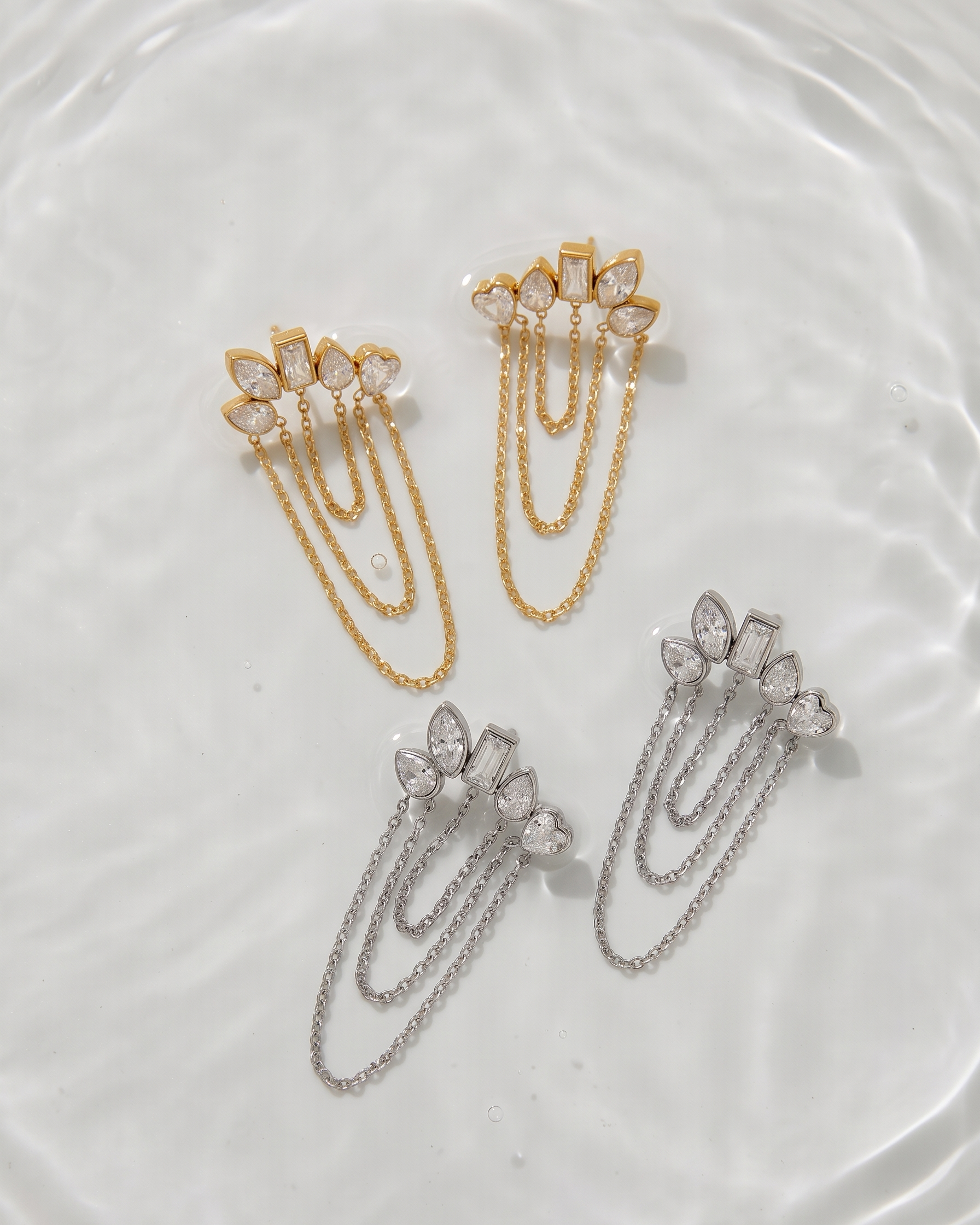 Gold and silver hair clips with gemstones on a white surface