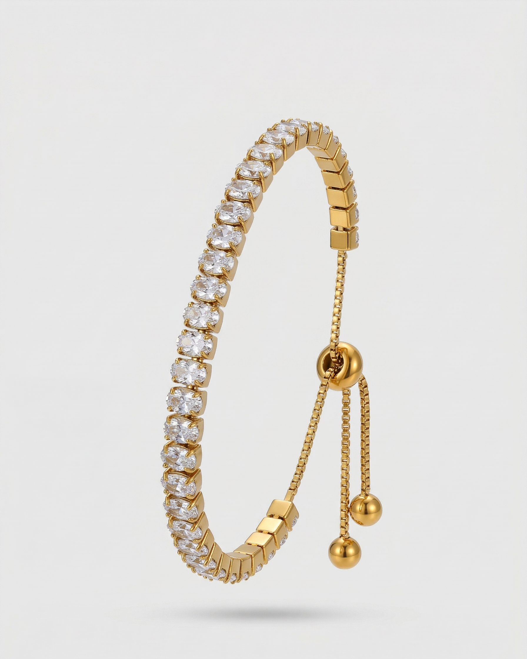 Gold bracelet with diamond accents on a light gray background