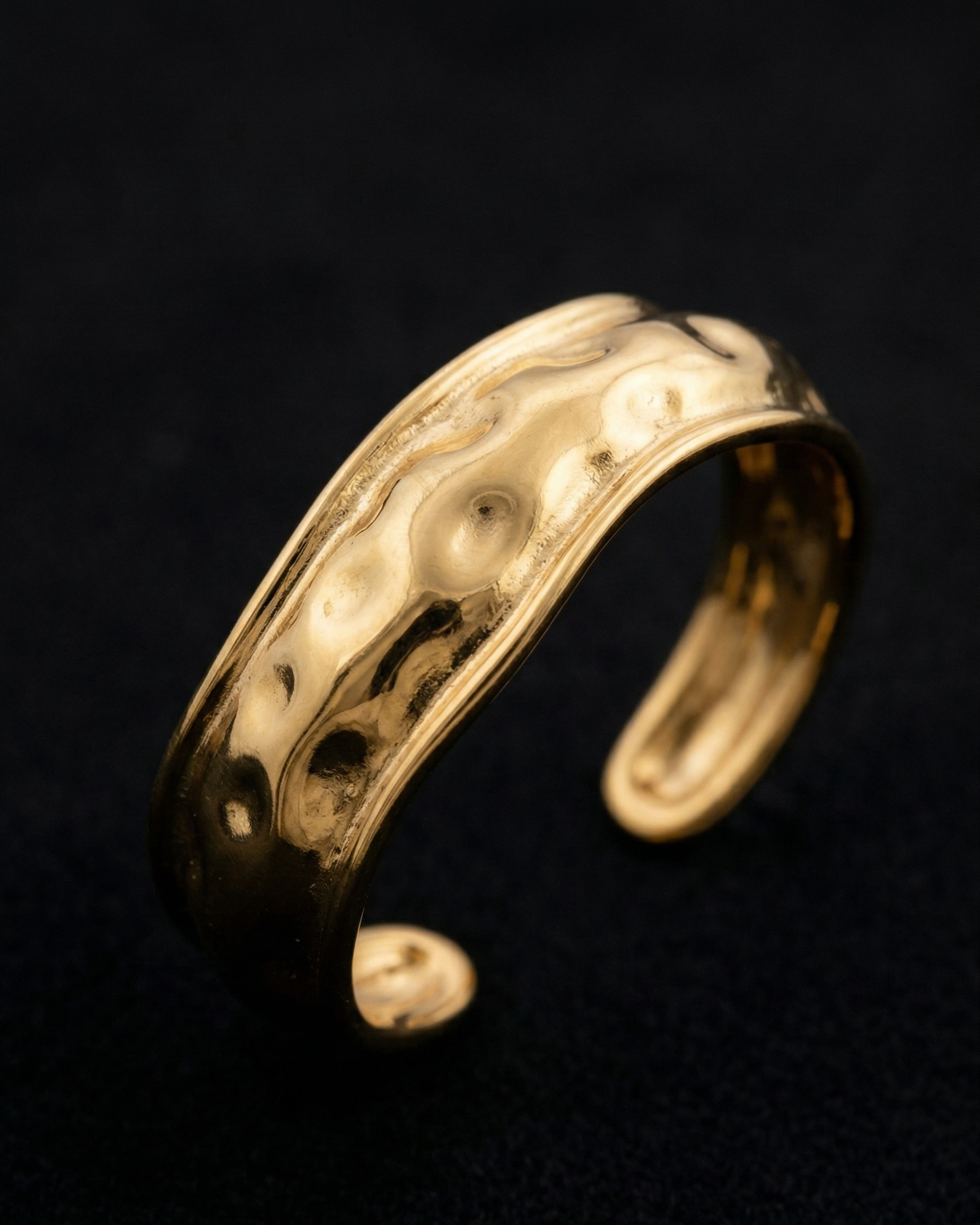 Gold bracelet on a dark background