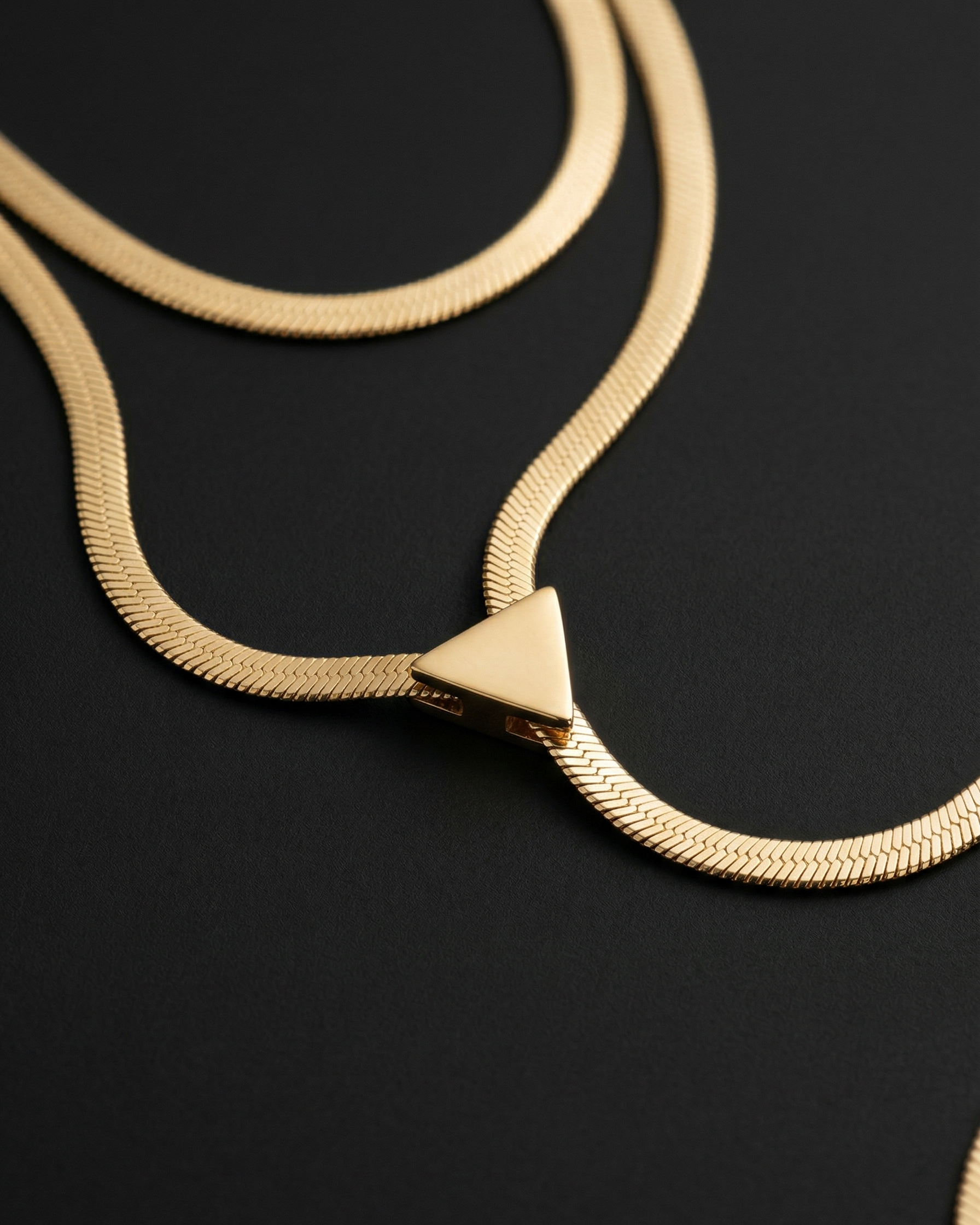 Gold necklace on a black background
