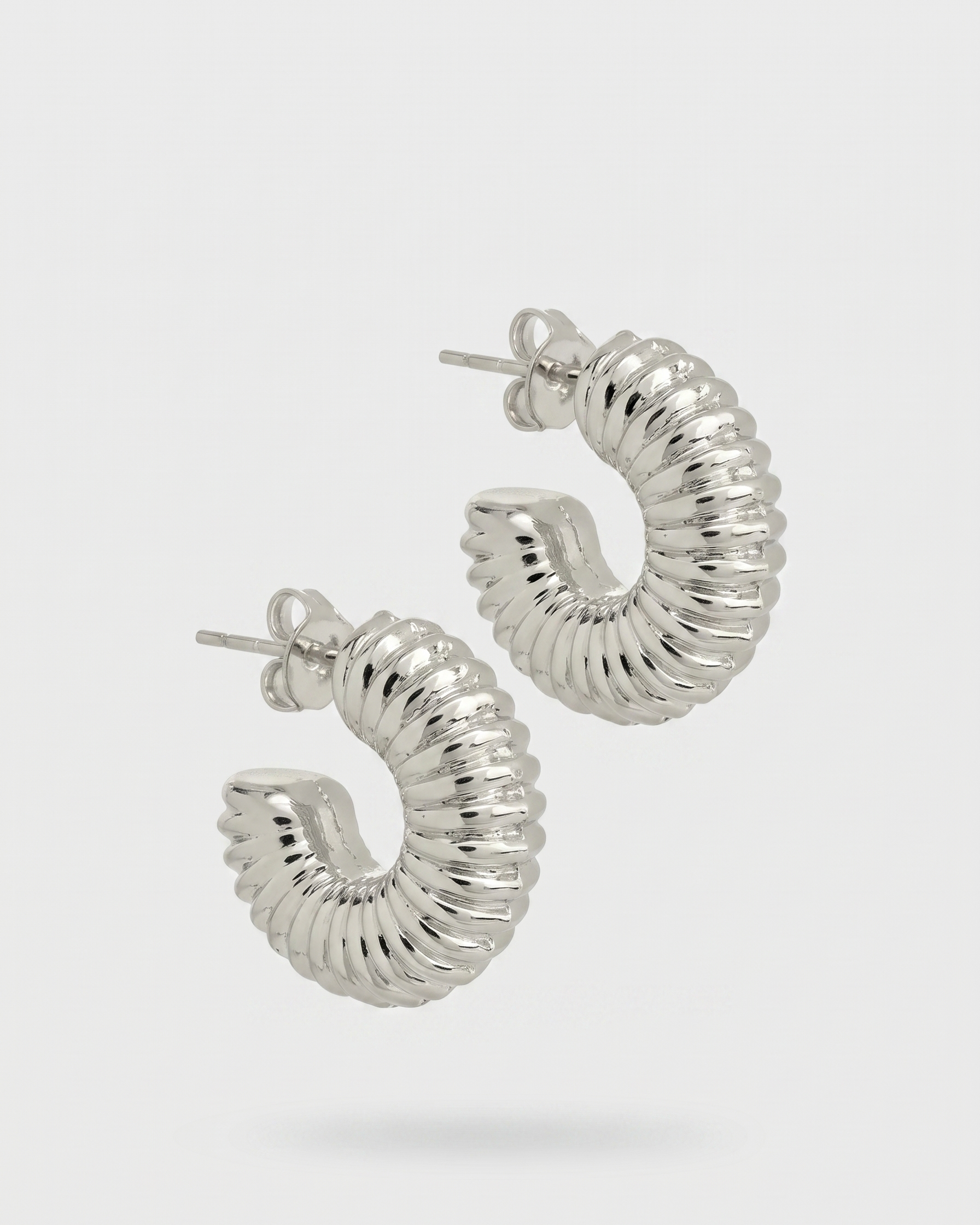 Silver hoop earrings on a white background
