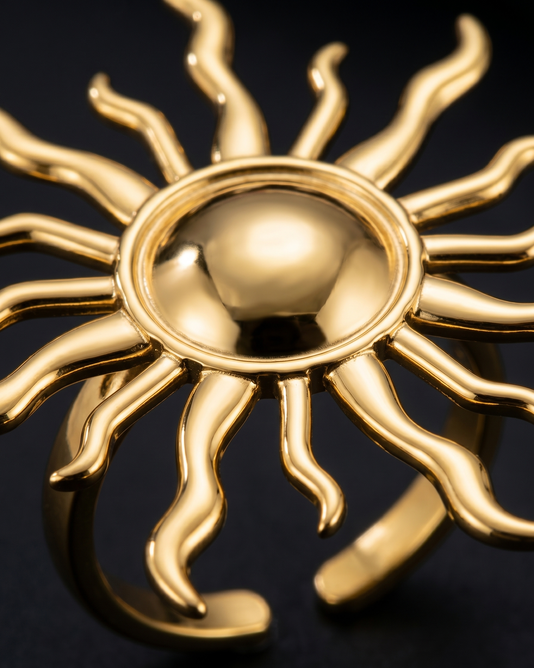 Gold sun-shaped object on a black background