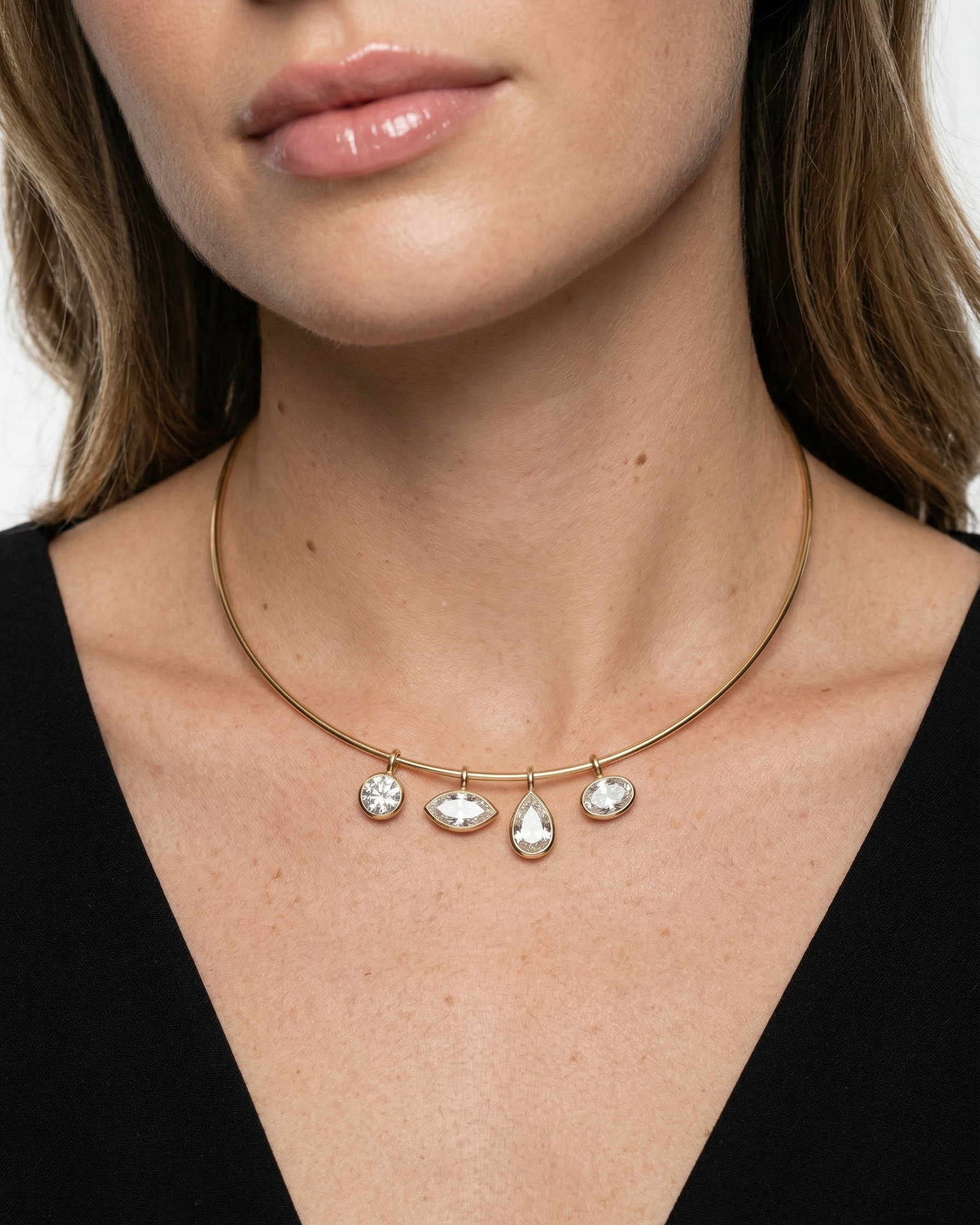 Necklace with three teardrop-shaped pendants on a plain background