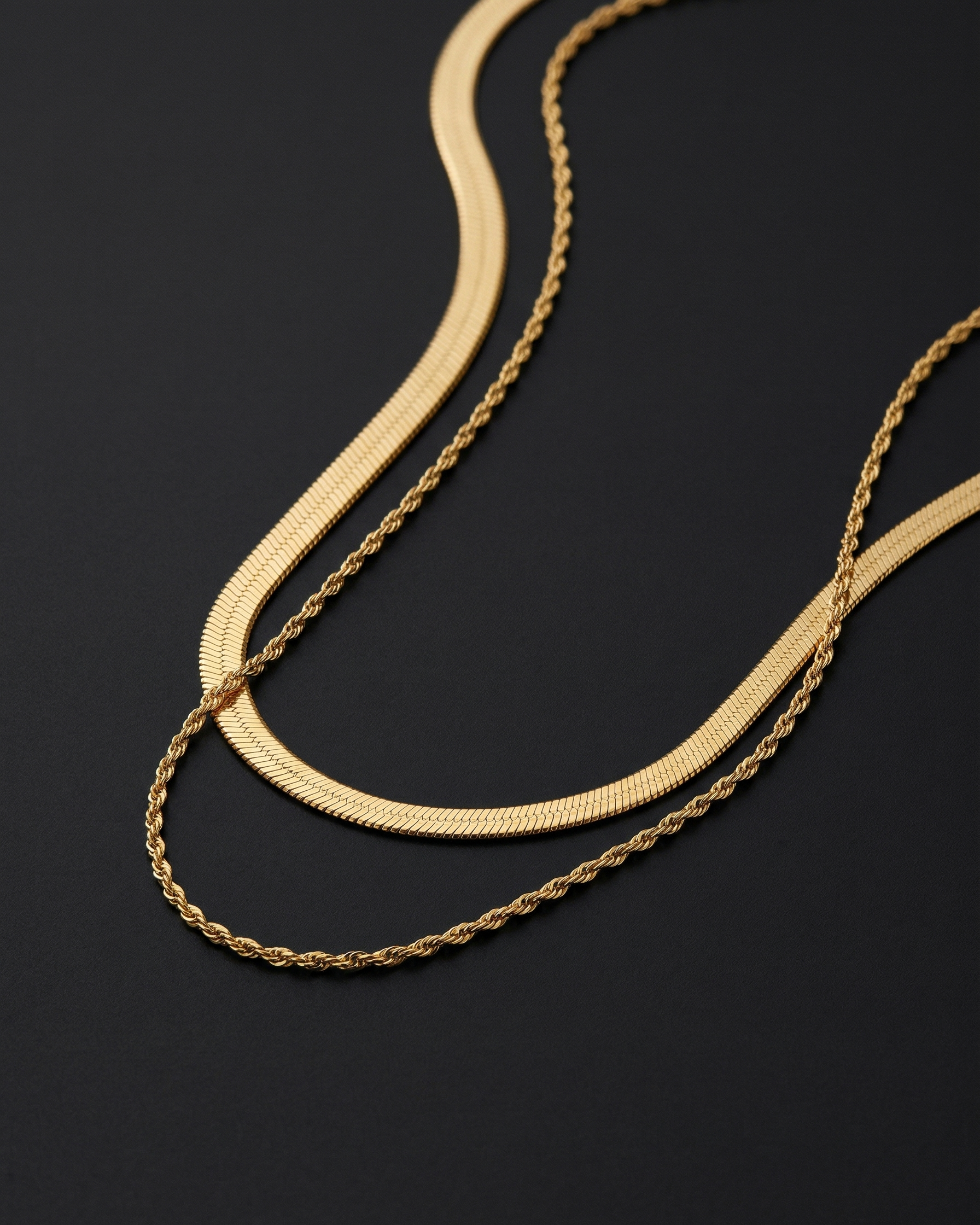 Gold chain necklace on a black background