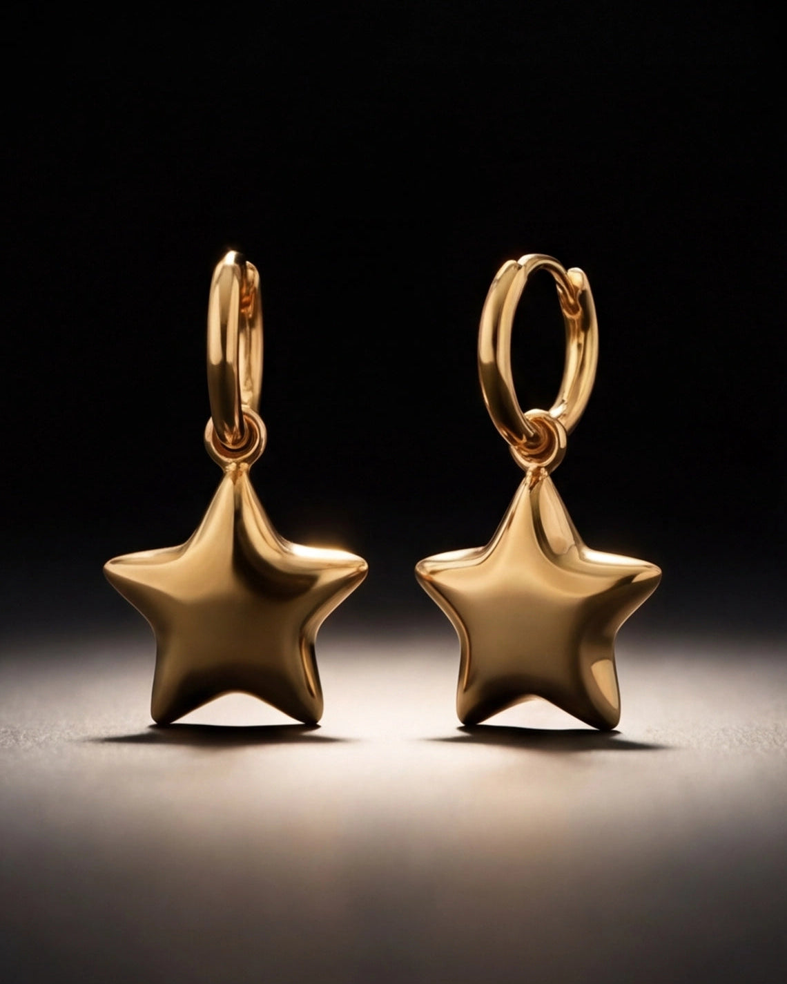 Gold star-shaped earrings on a dark background