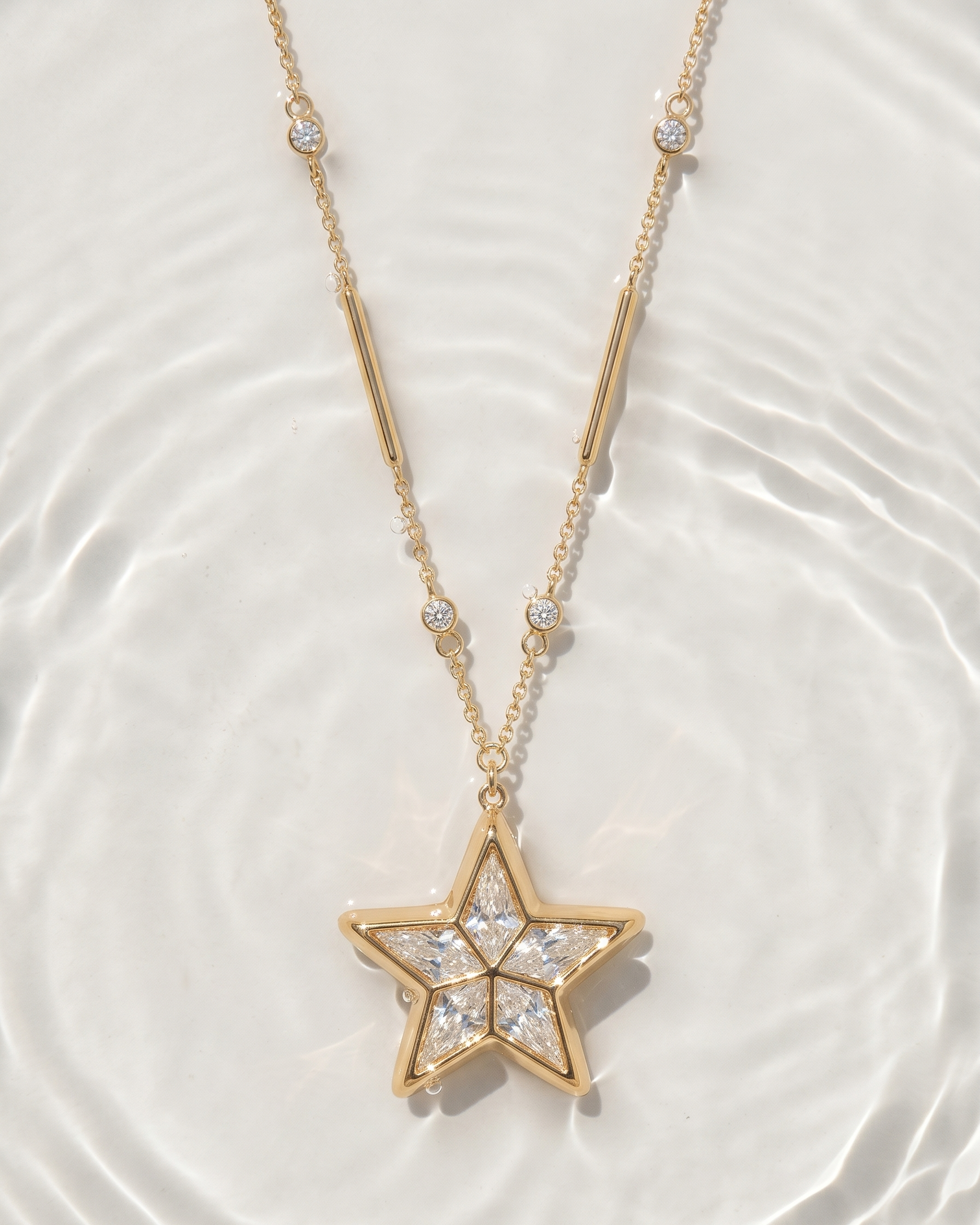 Gold star-shaped pendant necklace on a white background
