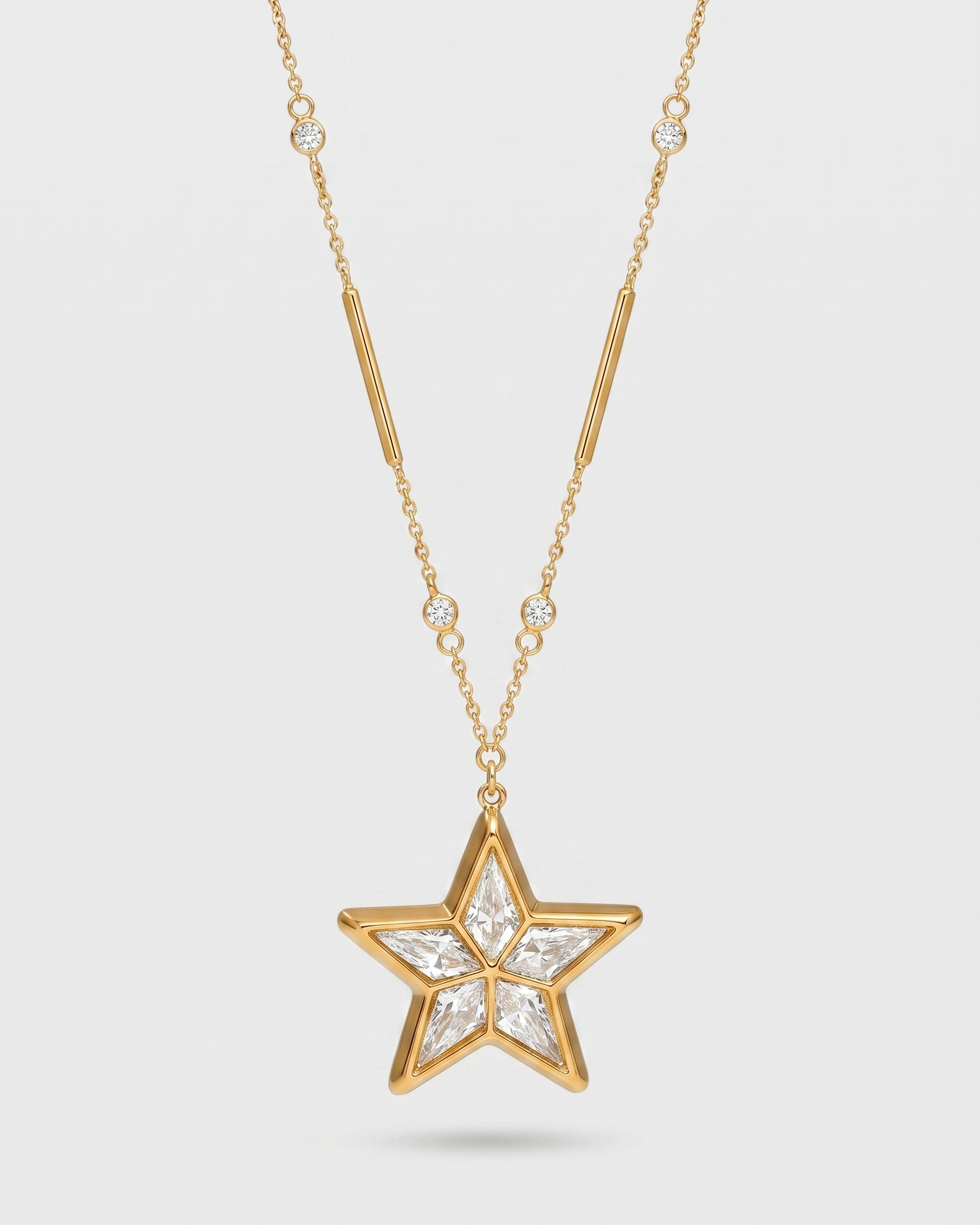 Gold star-shaped pendant necklace on a light gray background