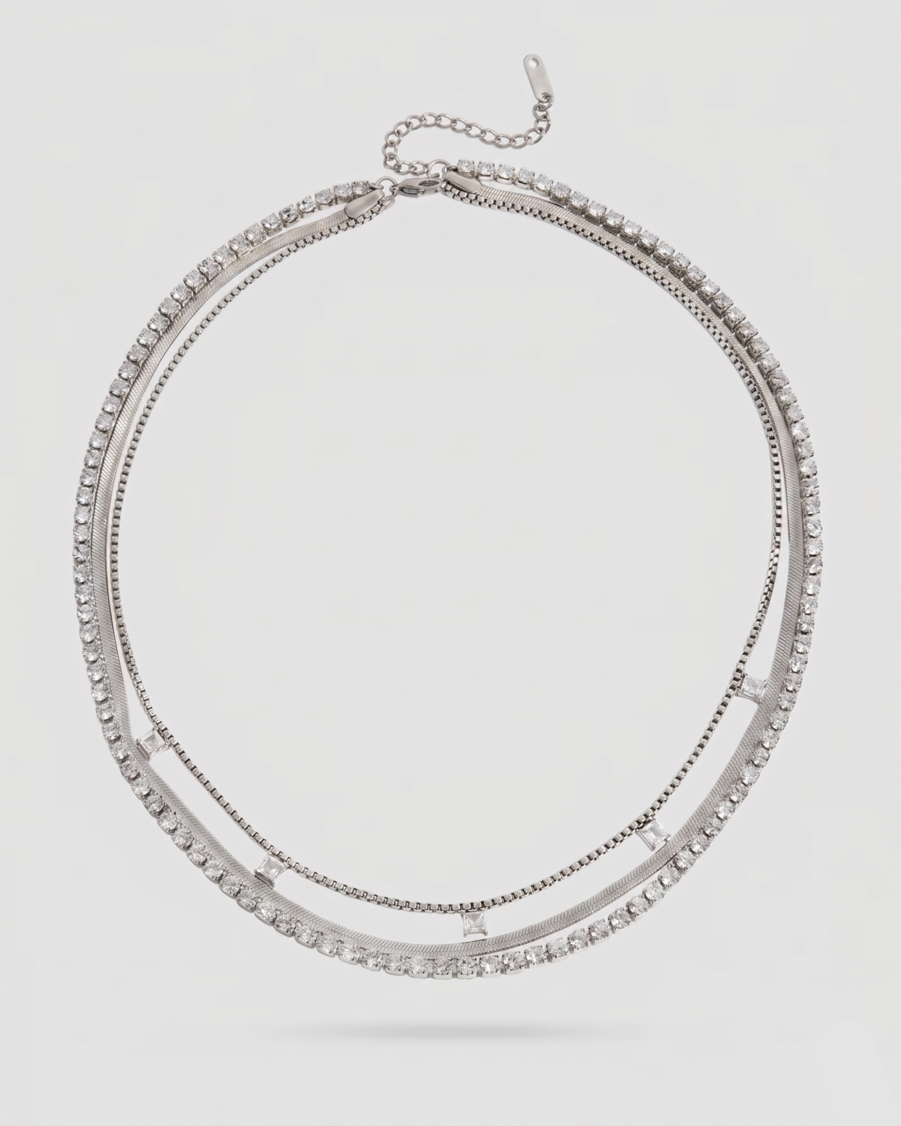 Silver layered necklace on a light gray background