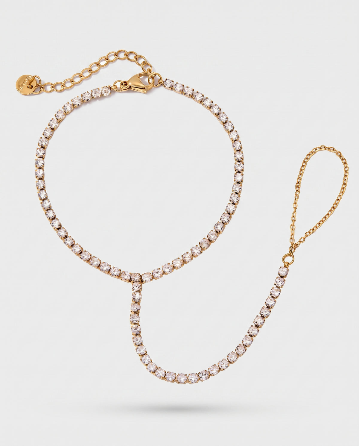 A gold chain necklace with clear rhinestones, featuring a circular top section, a central V-shaped drop, and an adjustable chain clasp with a small gold tag, shown on a light gray background.