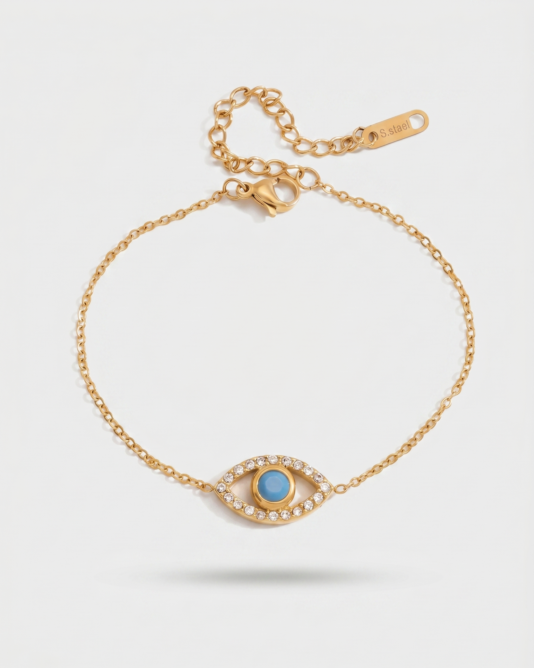Gold bracelet with a blue gemstone on a white background