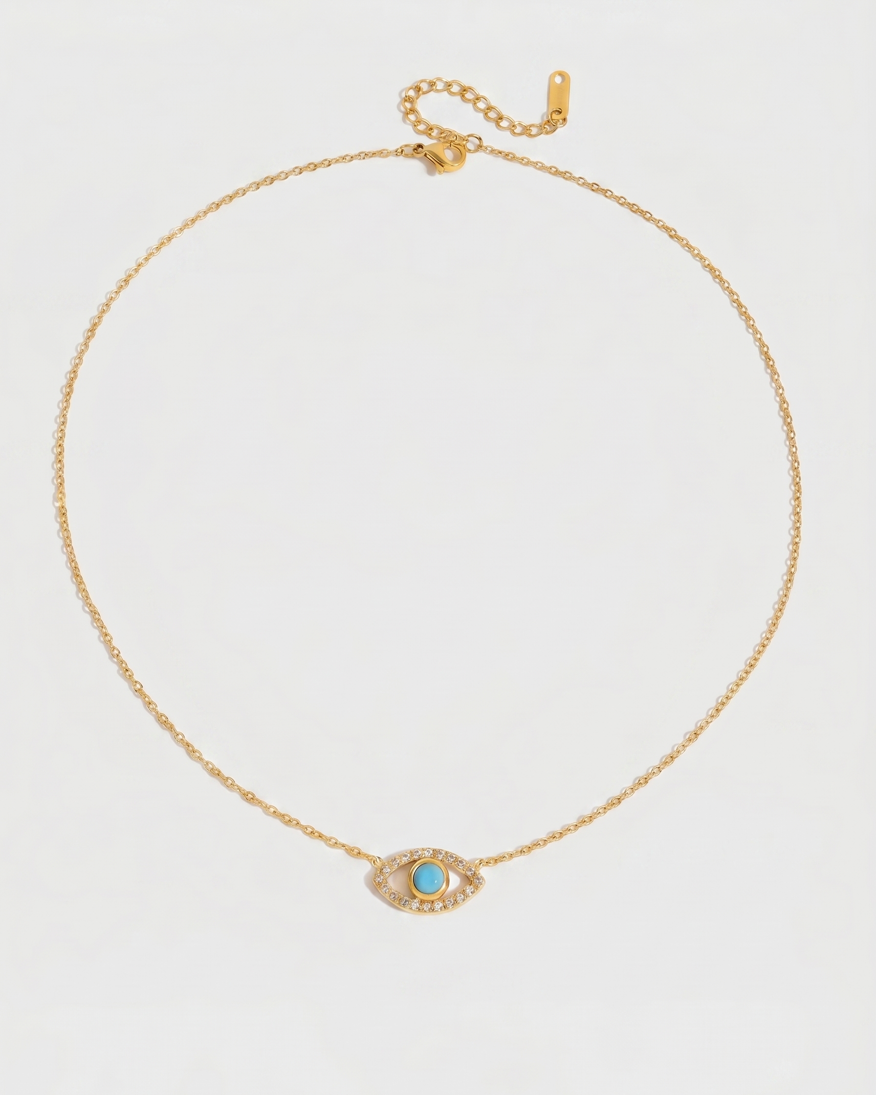 Gold necklace with a blue eye pendant on a white background
