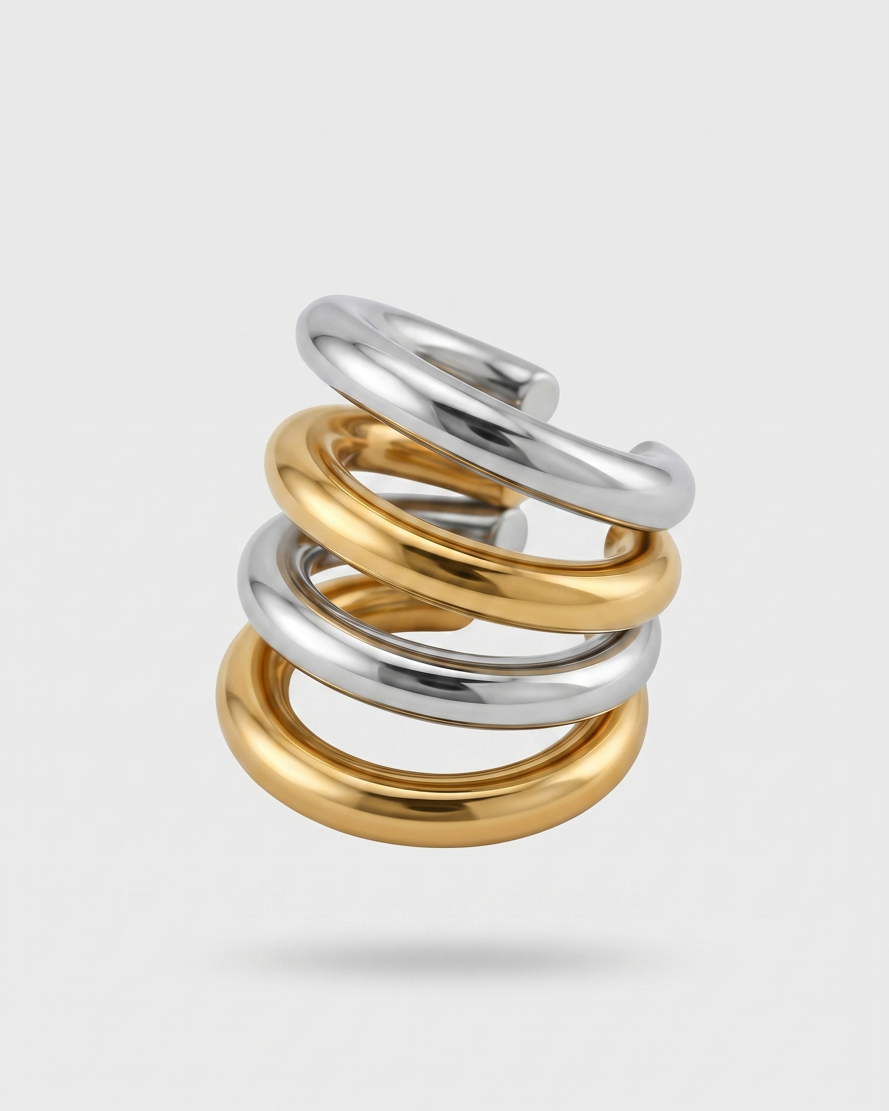 Three interlocking rings in gold and silver on a light gray background