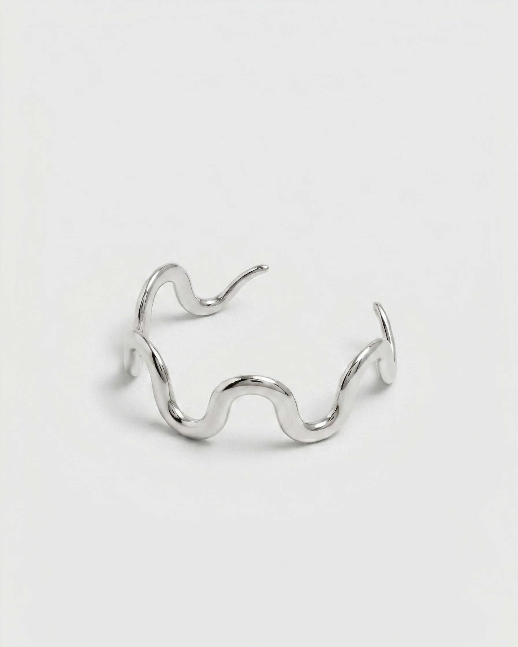 Silver wavy ring on a white background