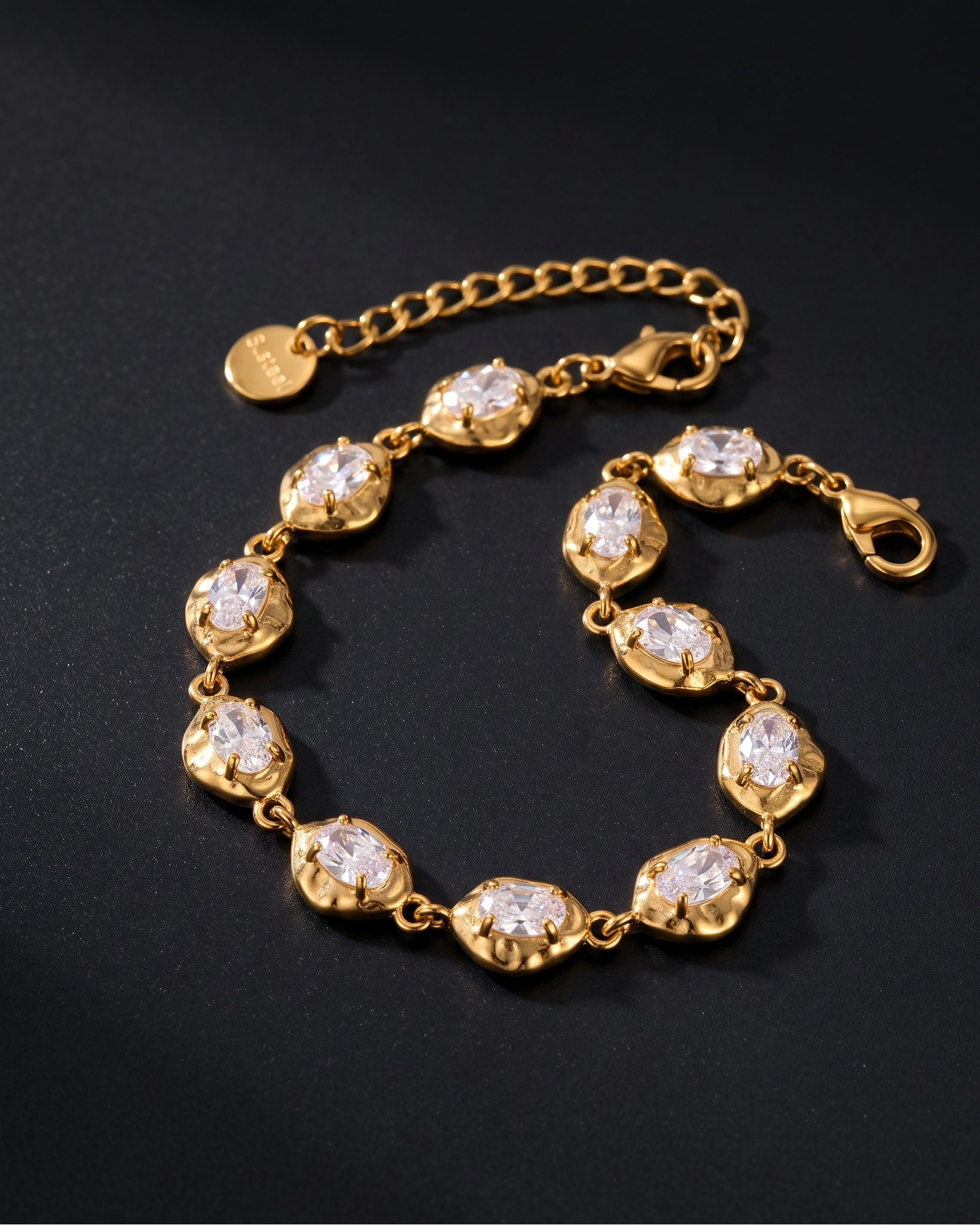 Gold bracelet with diamond-like stones on a black background