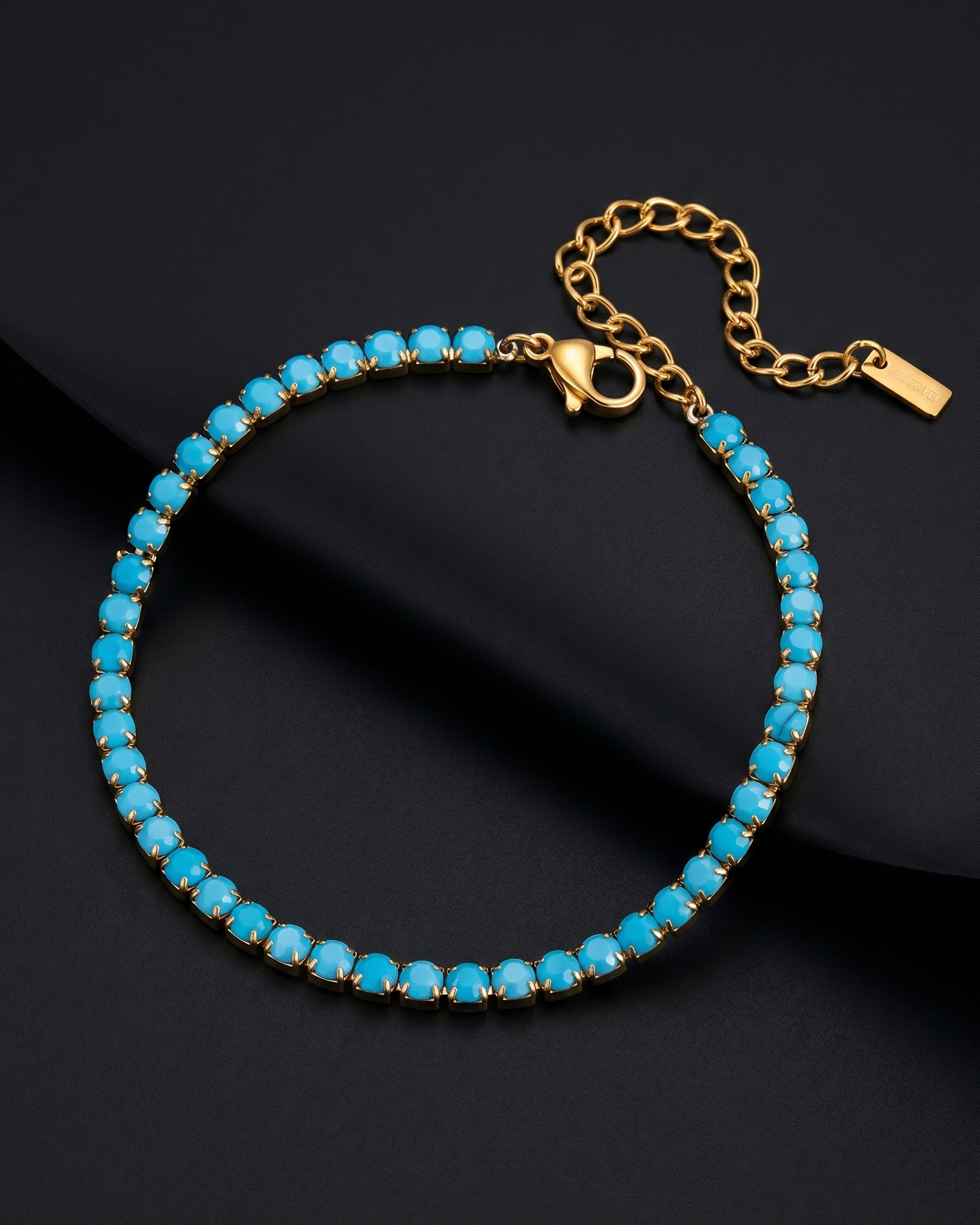 Turquoise beaded bracelet with gold chain on a black background