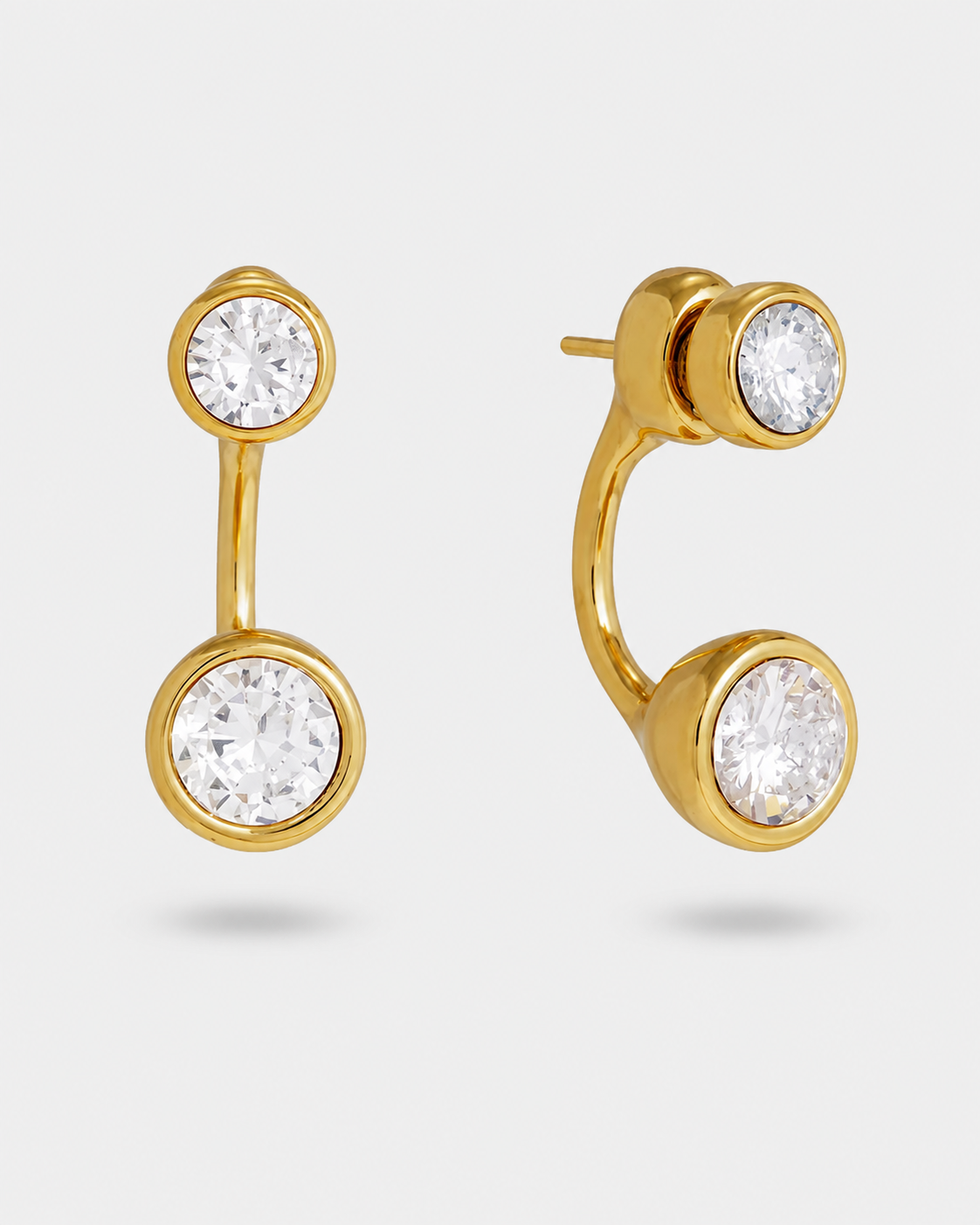 A pair of gold-plated earrings with round clear gemstones, shown from two angles against a light gray background.