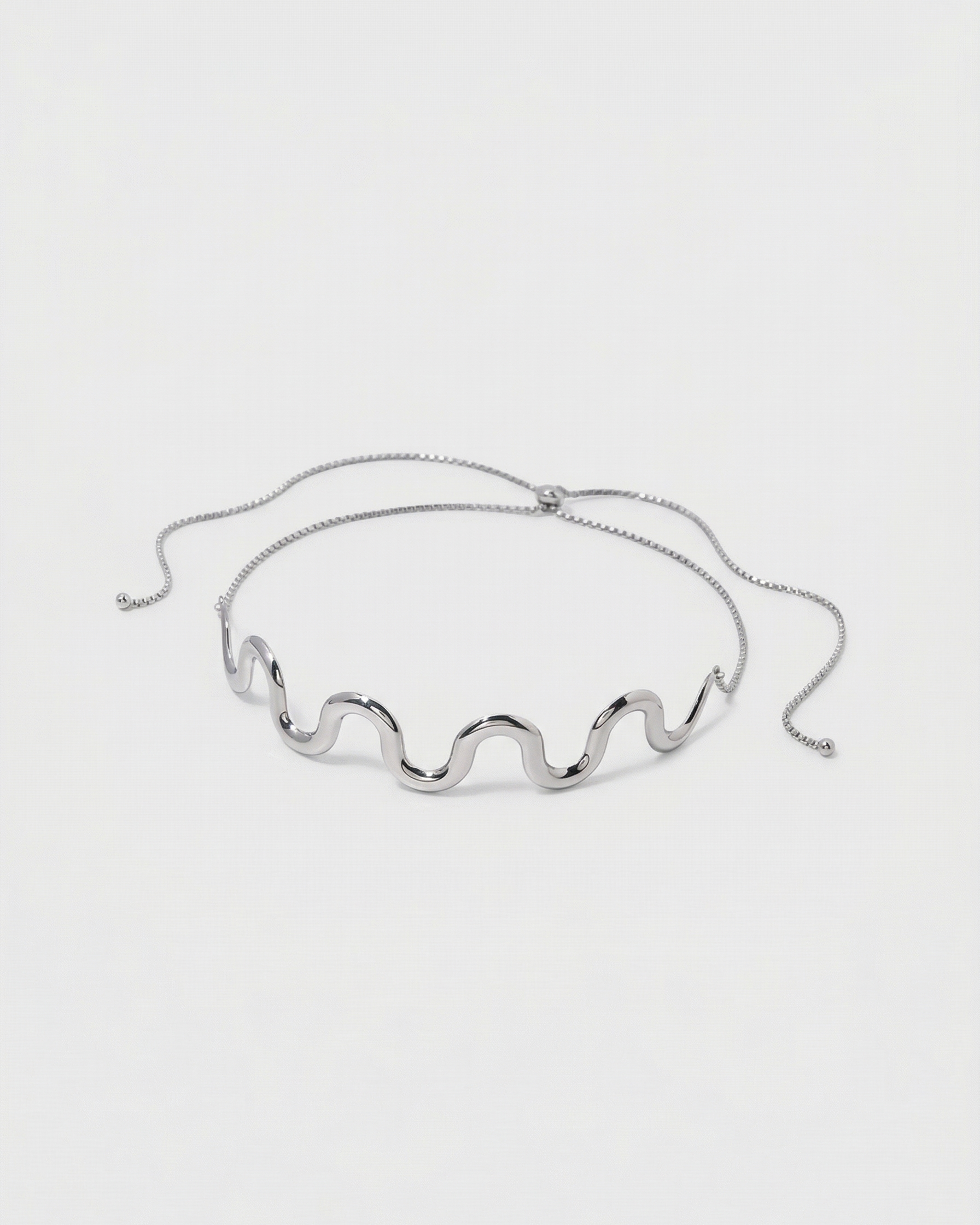 Silver wavy necklace on a white background