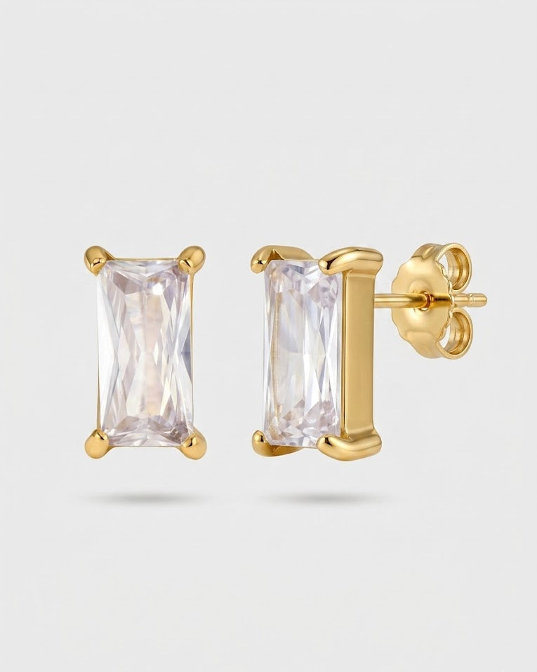 Gold stud earrings with clear gemstones on a white background