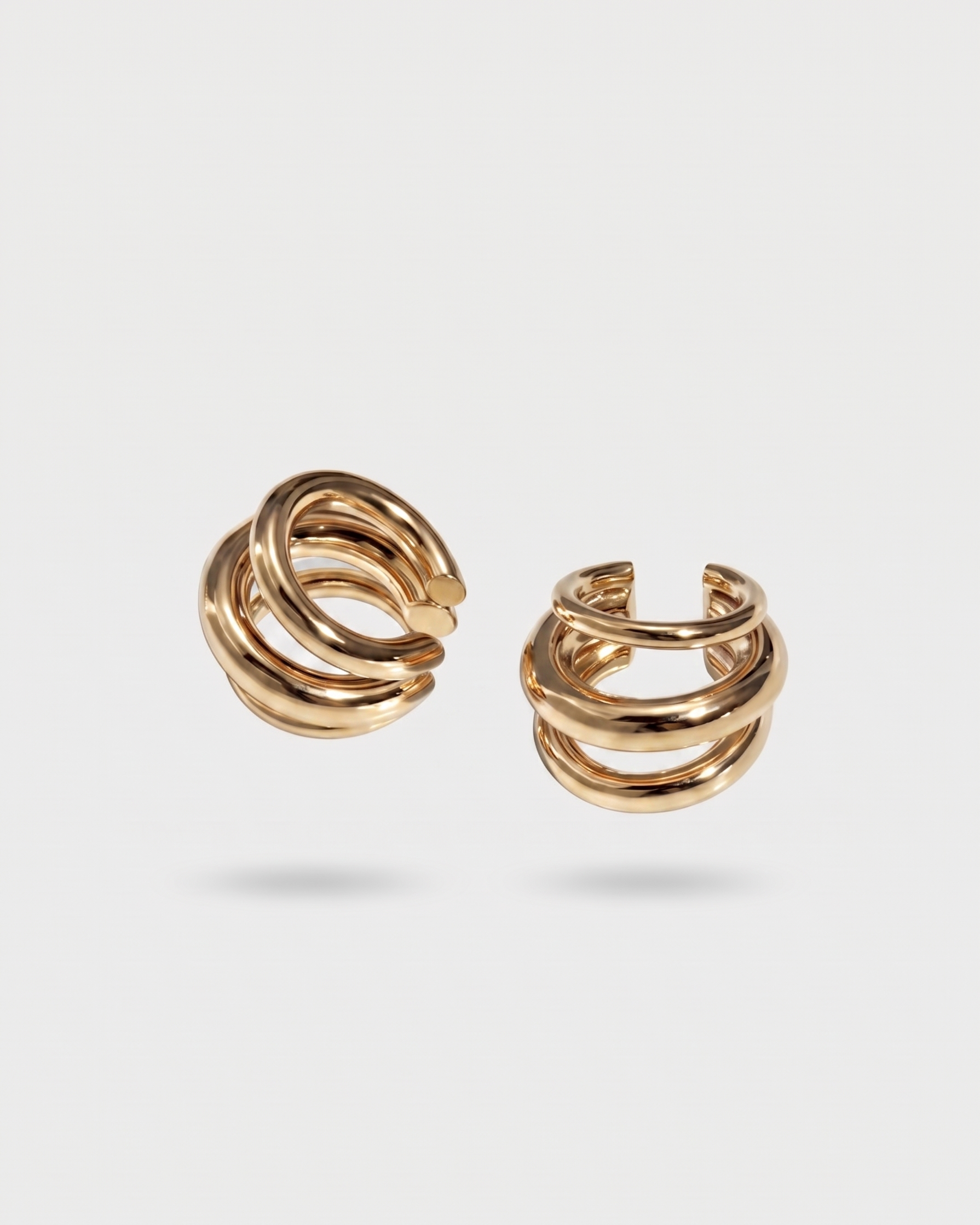 Pair of gold hoop earrings on a light gray background