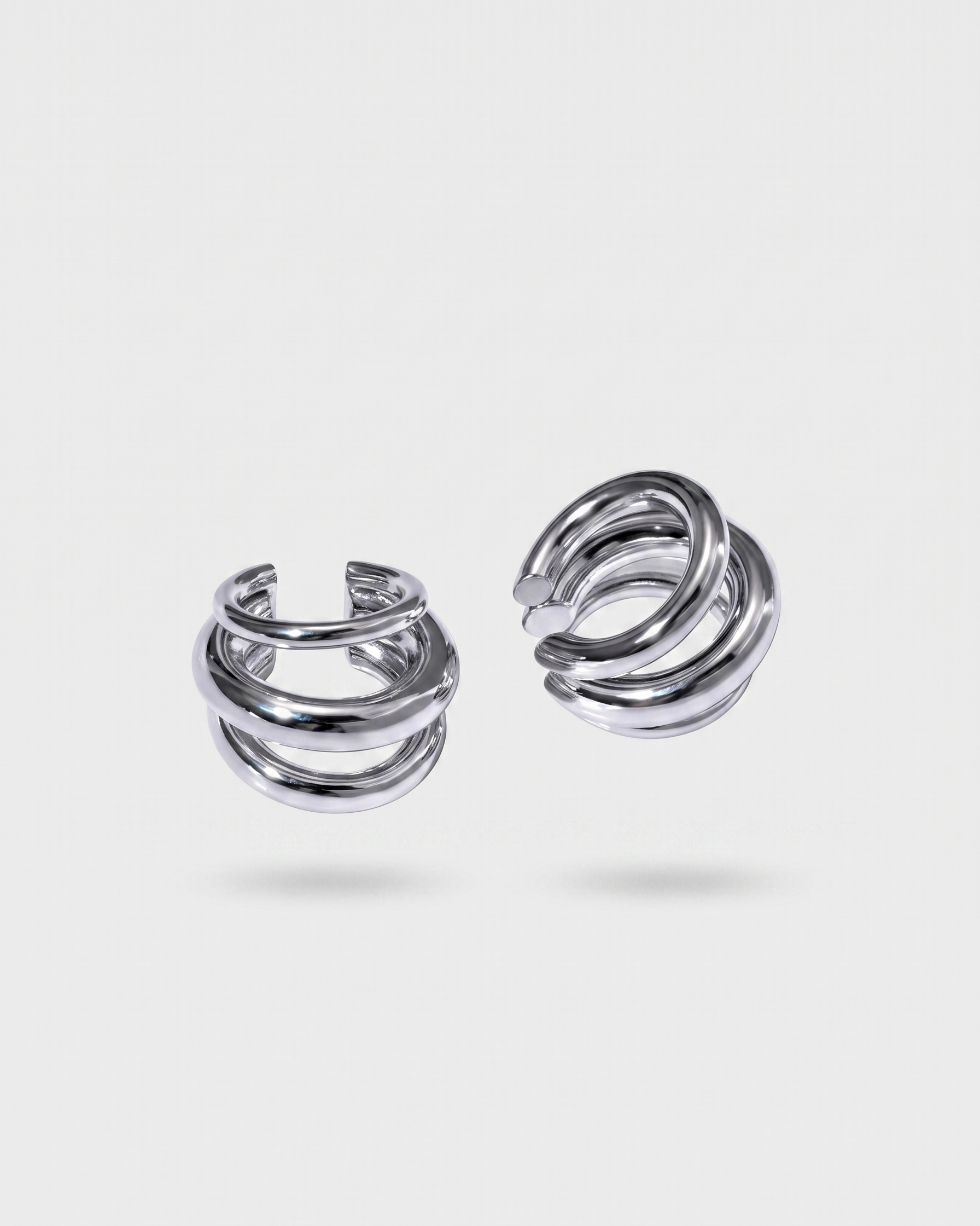 Pair of silver spiral earrings on a white background