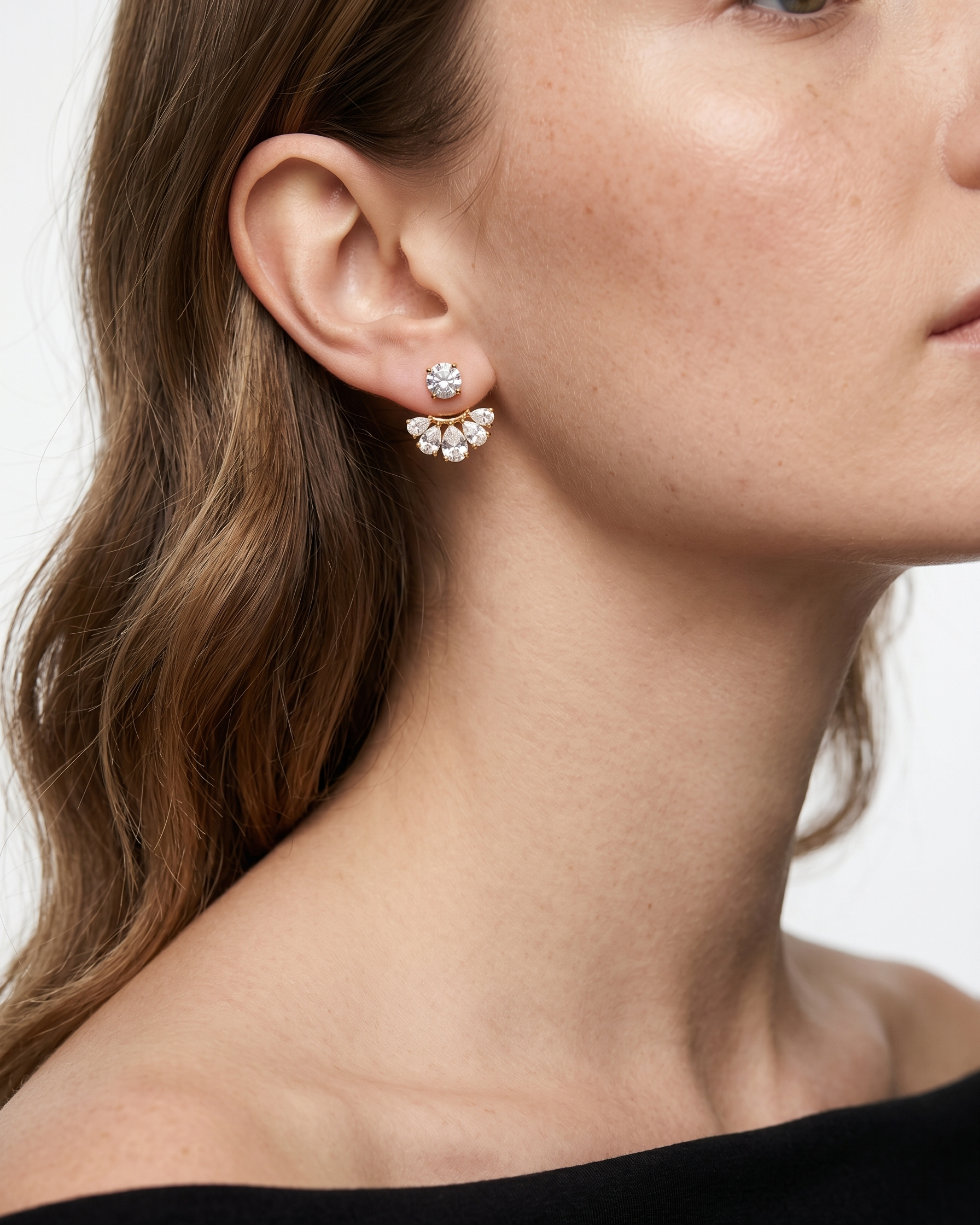 Close-up of a woman wearing a floral earring with a white background