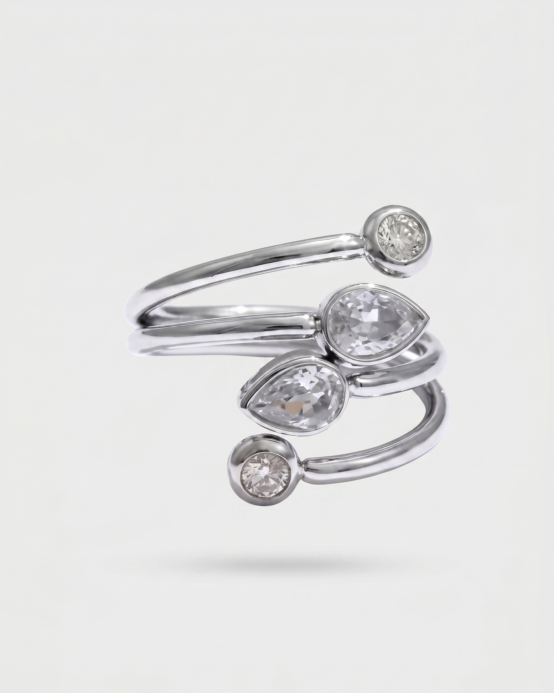 Silver ring with diamond accents on a light gray background