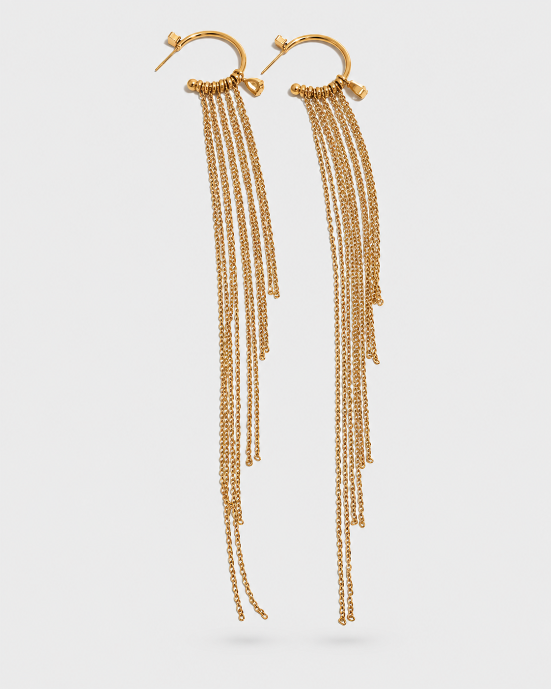 A pair of gold-toned dangle earrings with circular hoops and multiple cascading chain strands, shown against a light gray background.