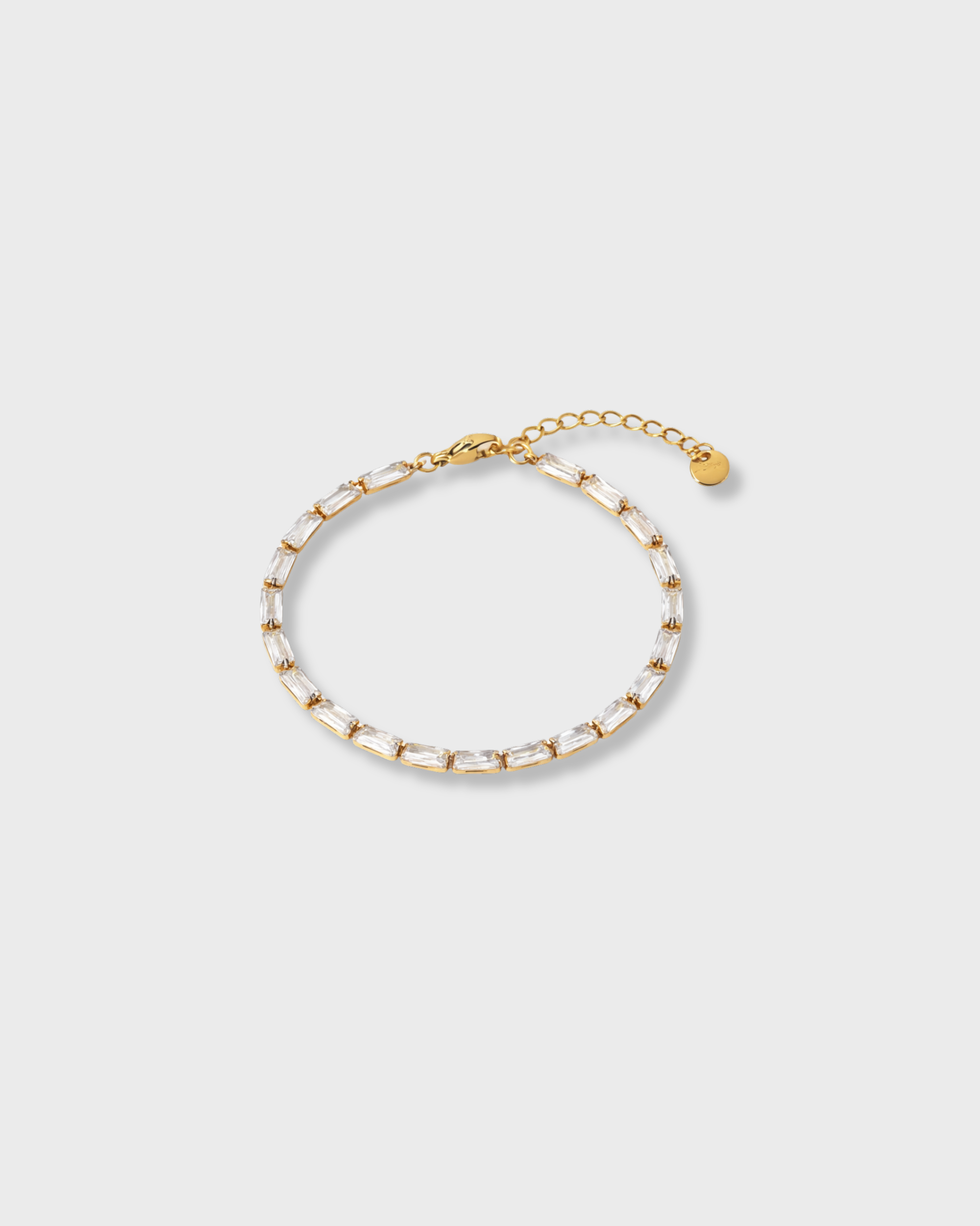 Gold bracelet on a light gray background