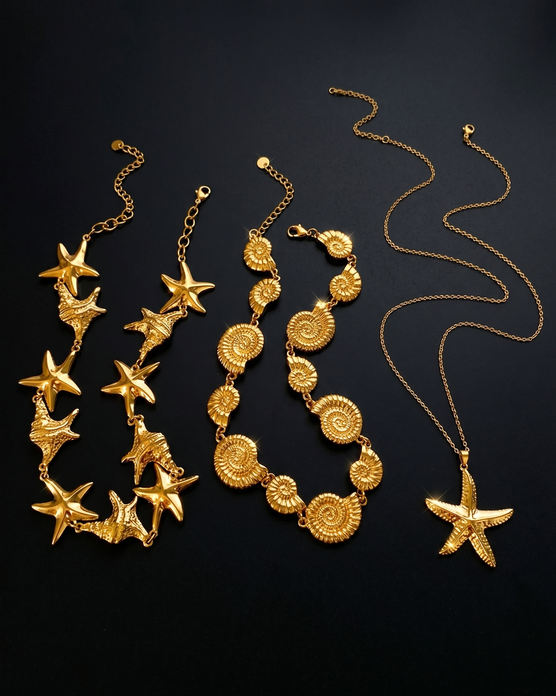 Gold necklaces with starfish designs on a black background