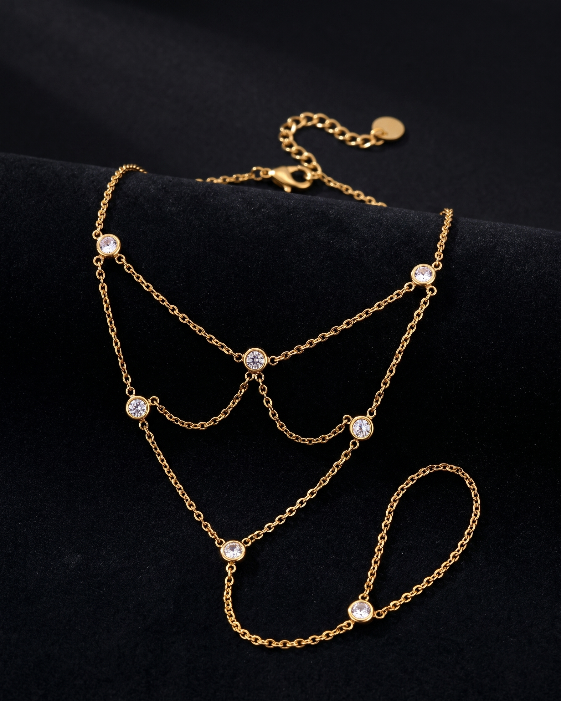 Gold necklace with small gemstones on a black background