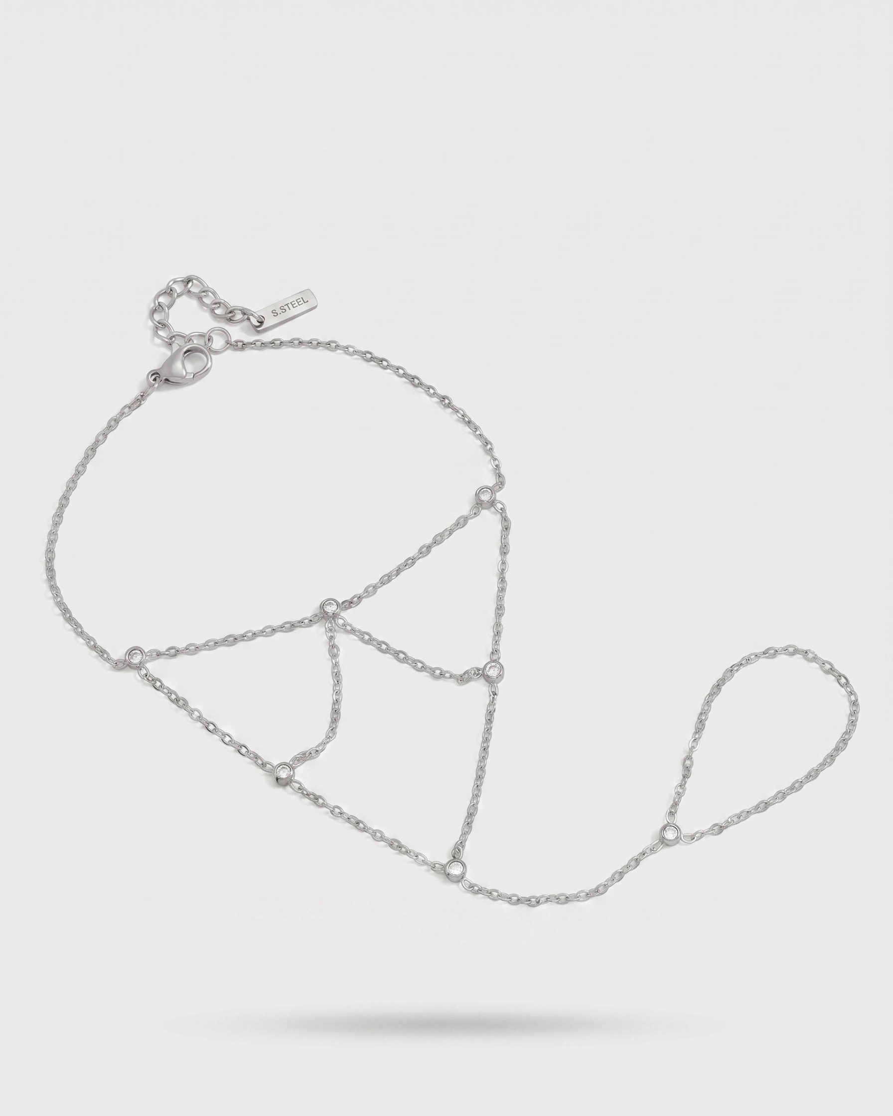 Silver chain necklace on a light gray background