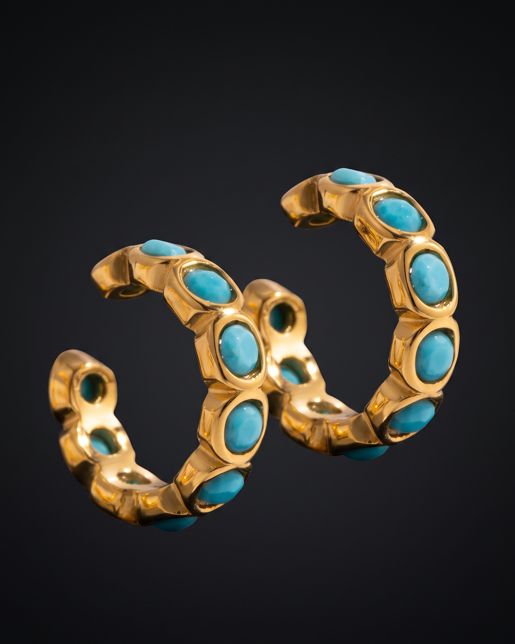 Gold and turquoise earring on a black background