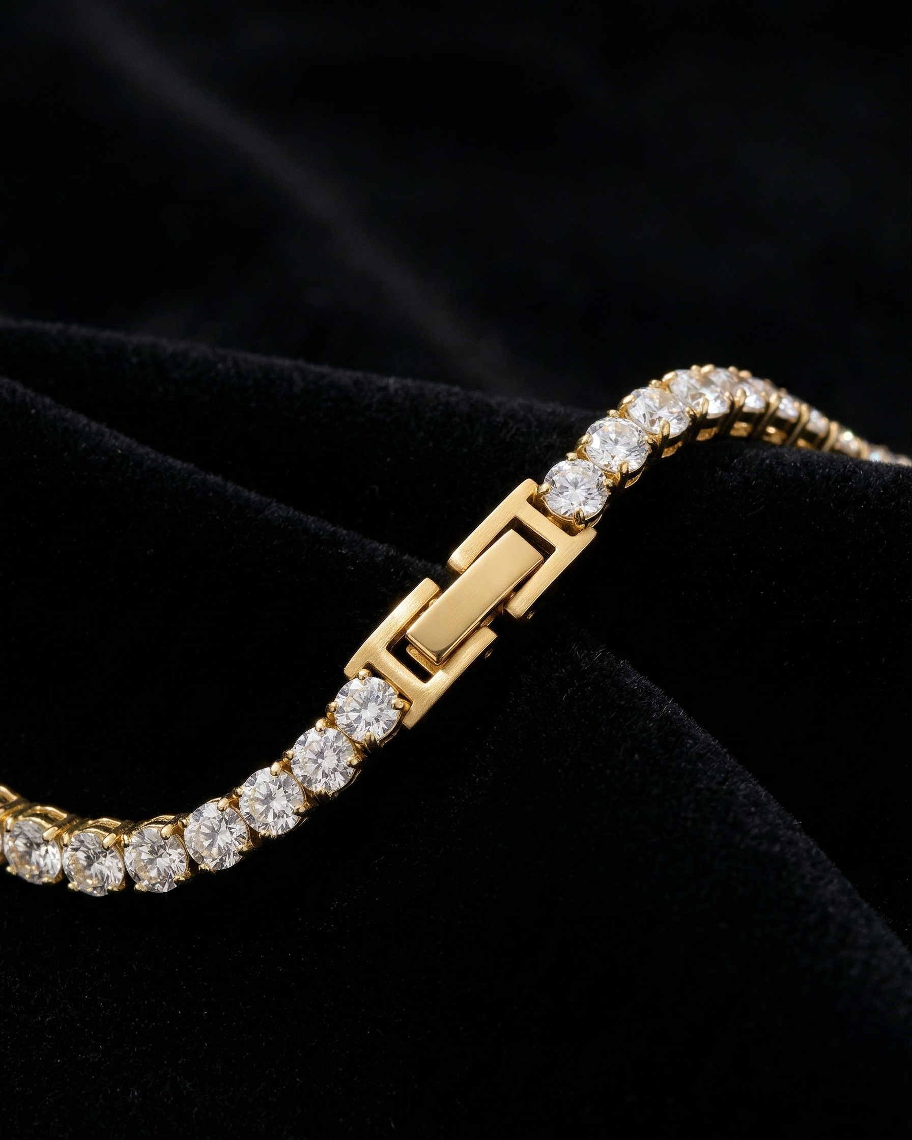 Gold bracelet with diamond accents on a black background