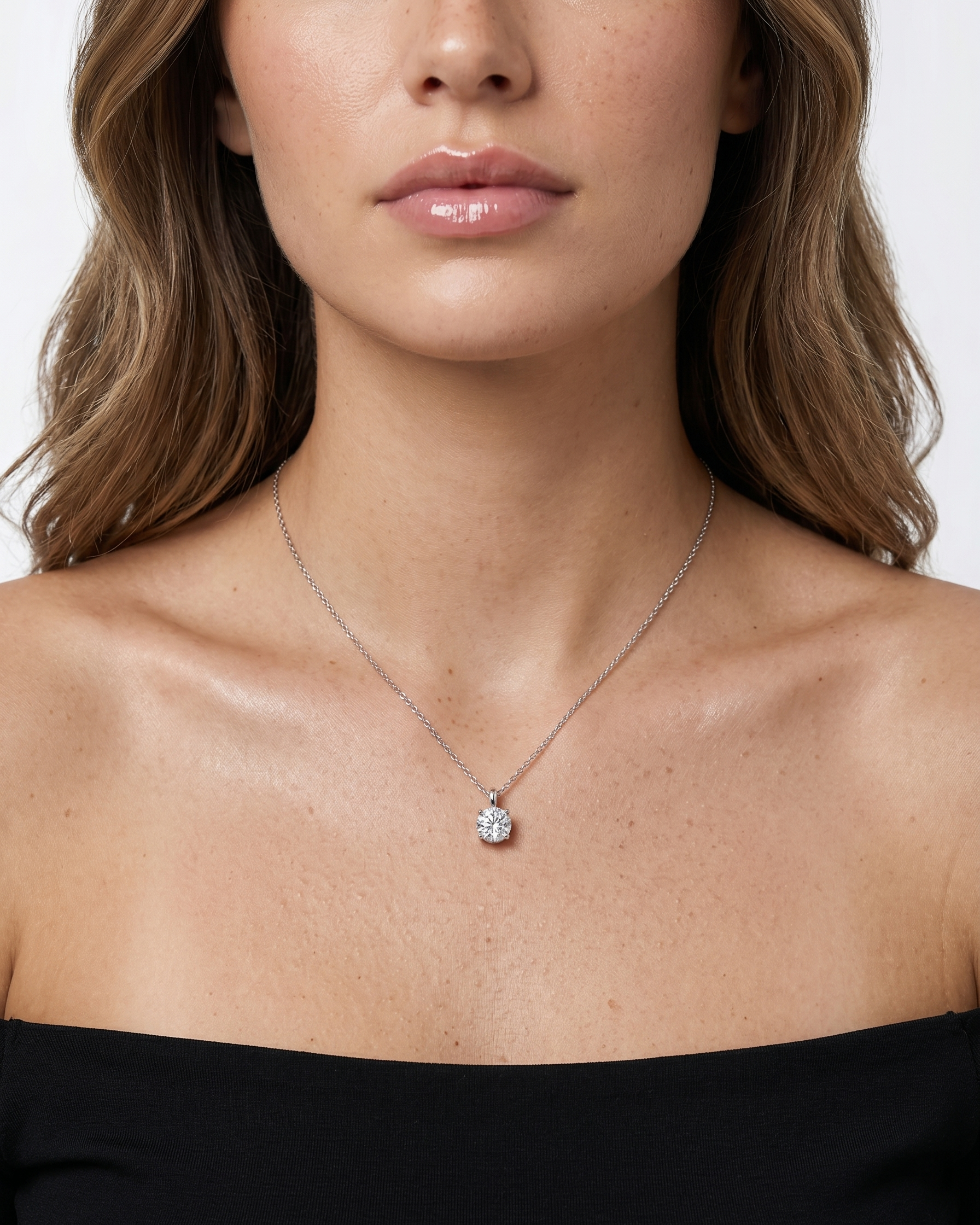 Necklace with a diamond pendant worn by a model on a white background