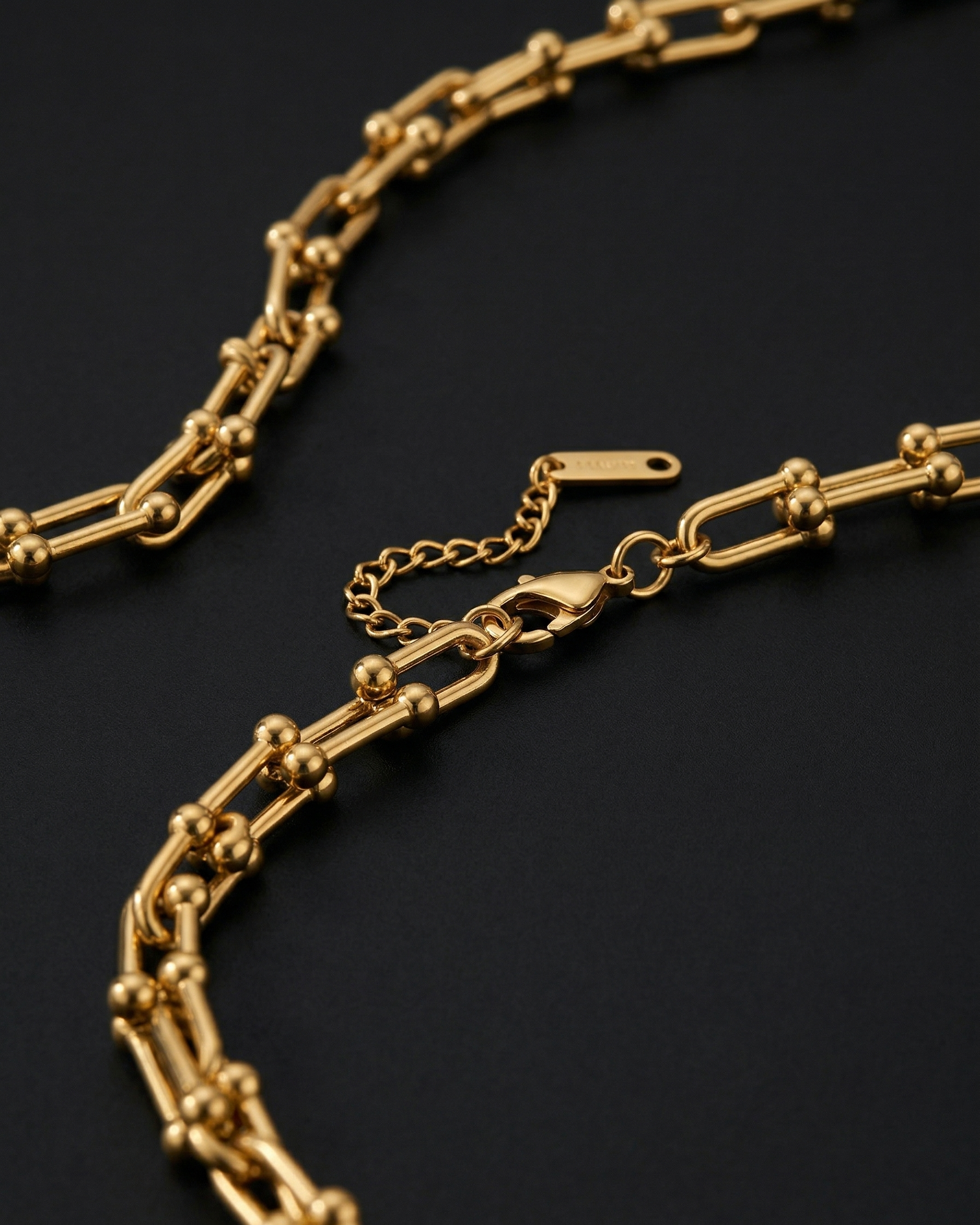 Gold chain necklace on a dark background