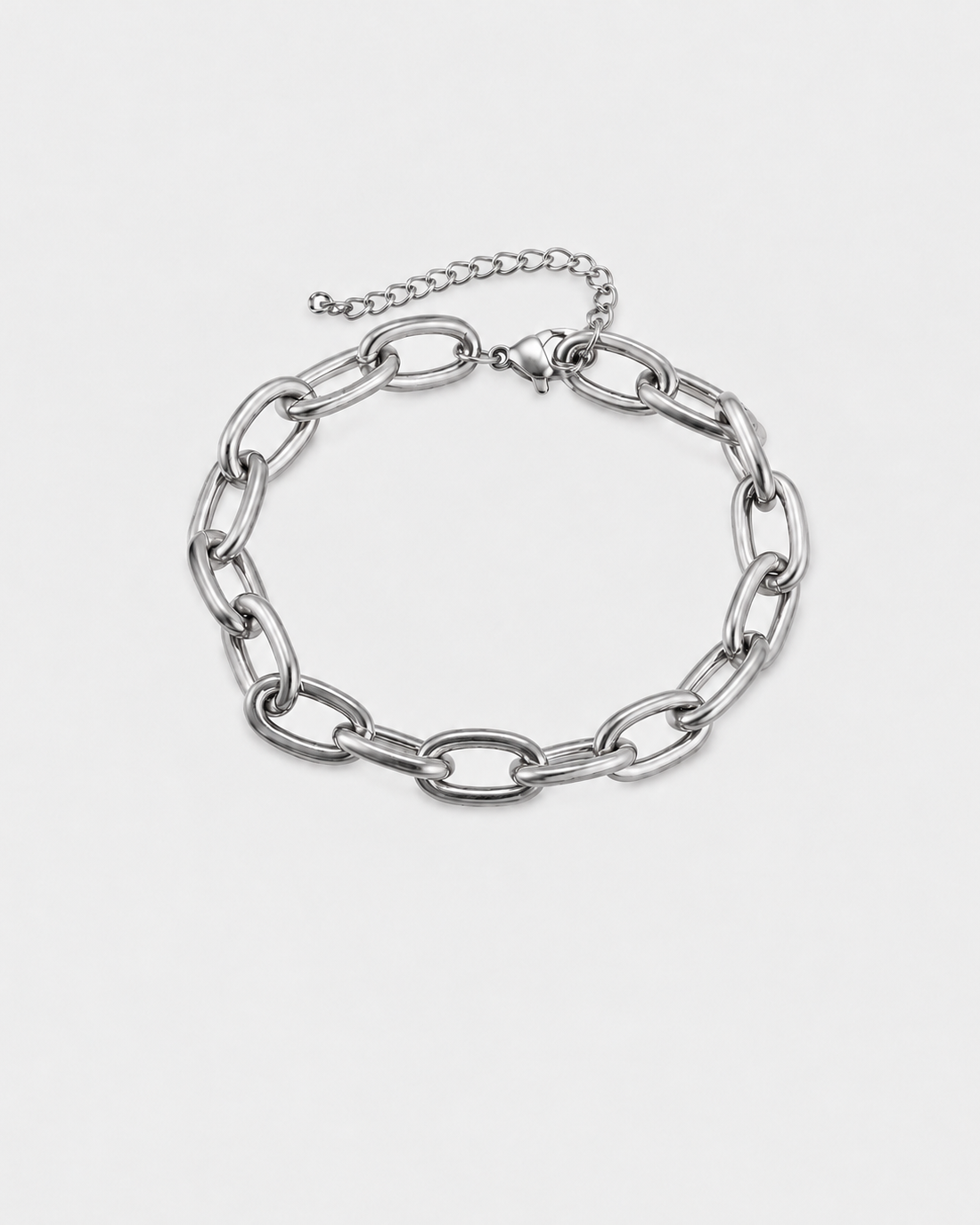 A silver-toned chain link bracelet with large oval links and a smaller extender chain with clasp, shown on a light gray background.