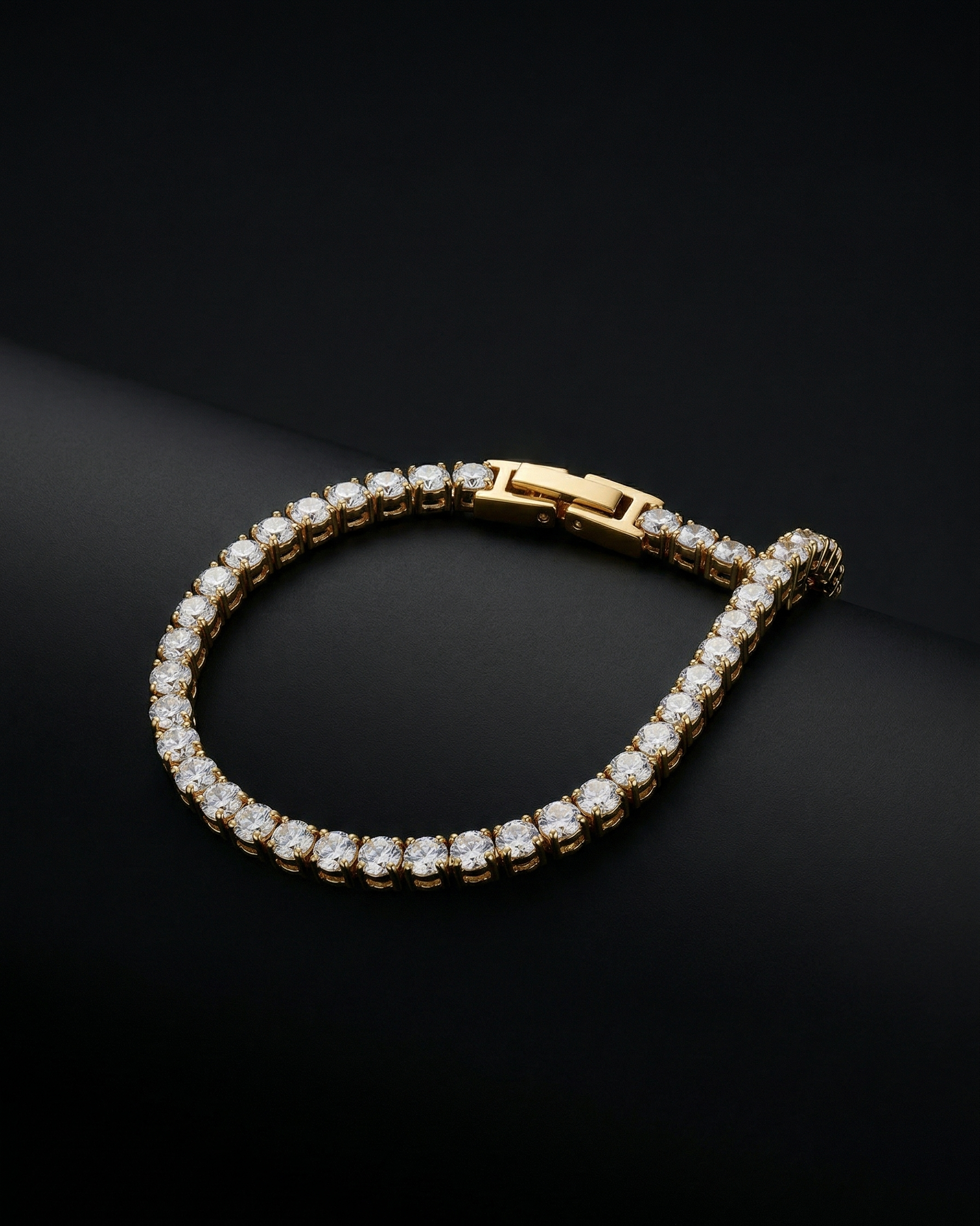 Gold bracelet with diamonds on a black background
