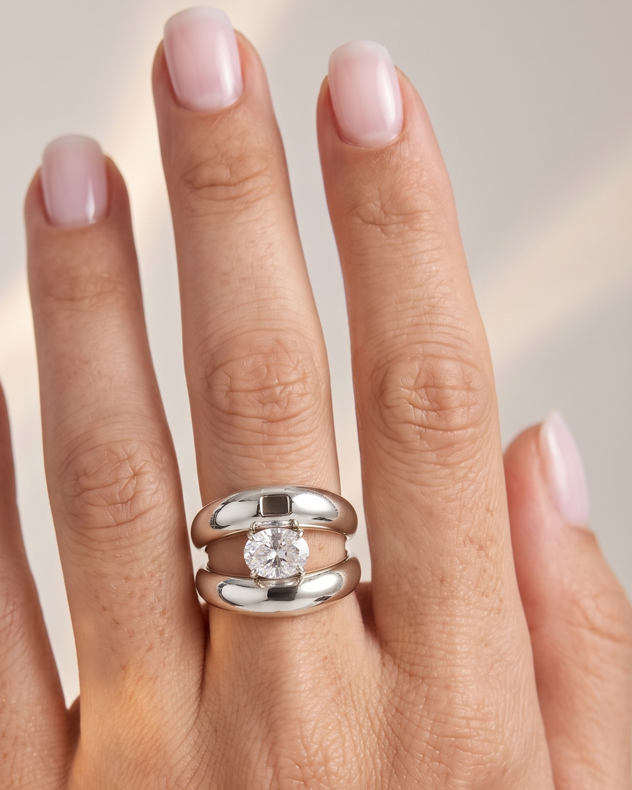Silver ring on a hand with a soft background