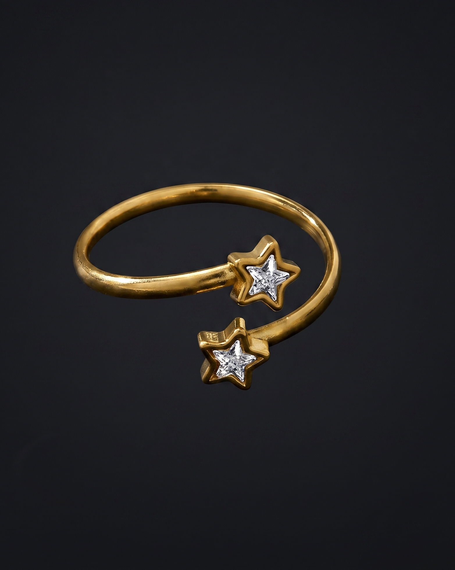 Gold ring with star-shaped diamond pendants on a black background