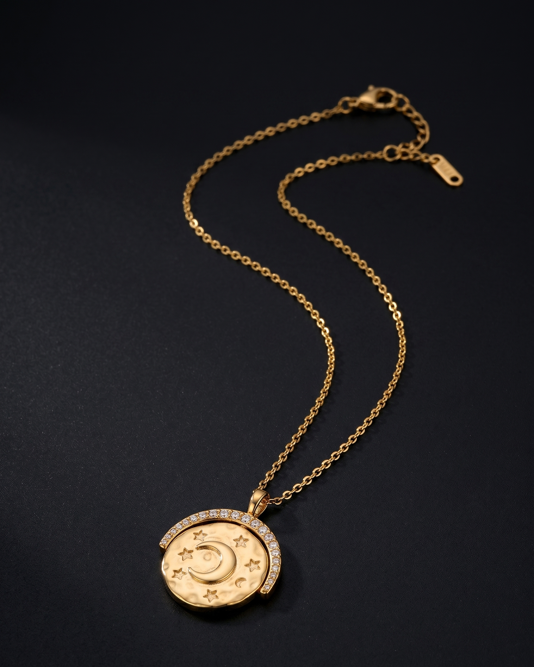 Gold necklace with a decorative pendant on a black background