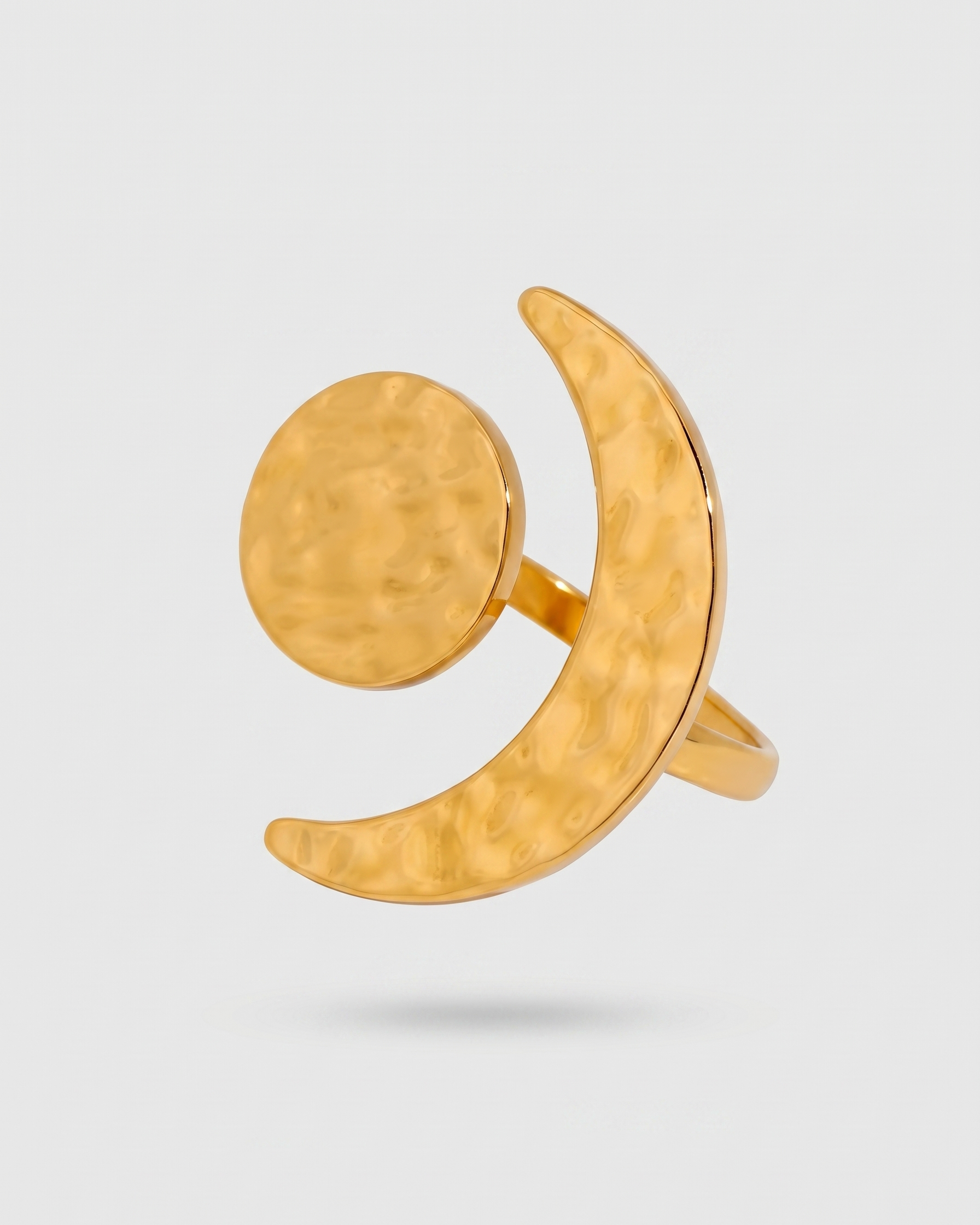 Gold ring with a unique design on a light gray background