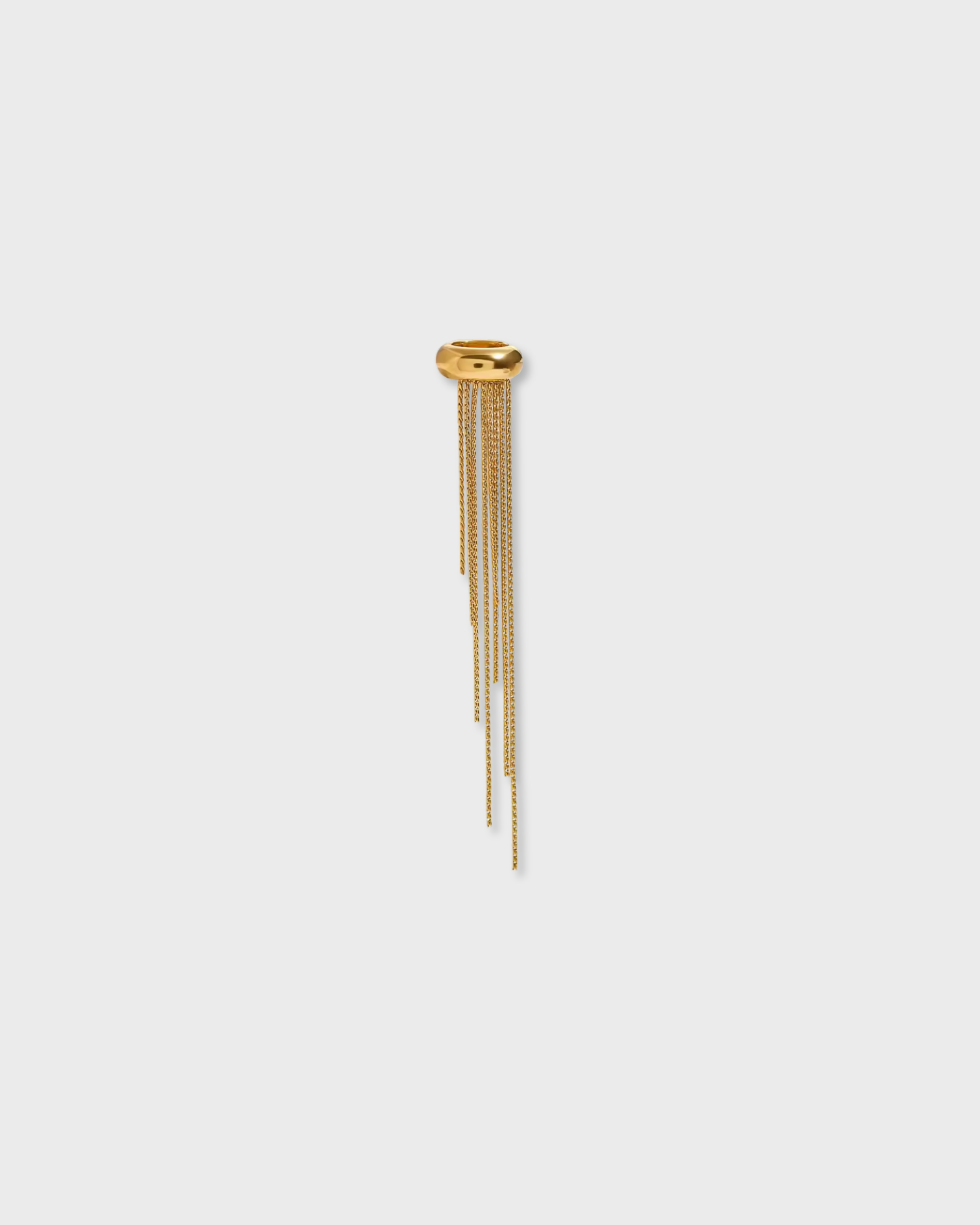 Gold hairpin with dangling elements on a light gray background