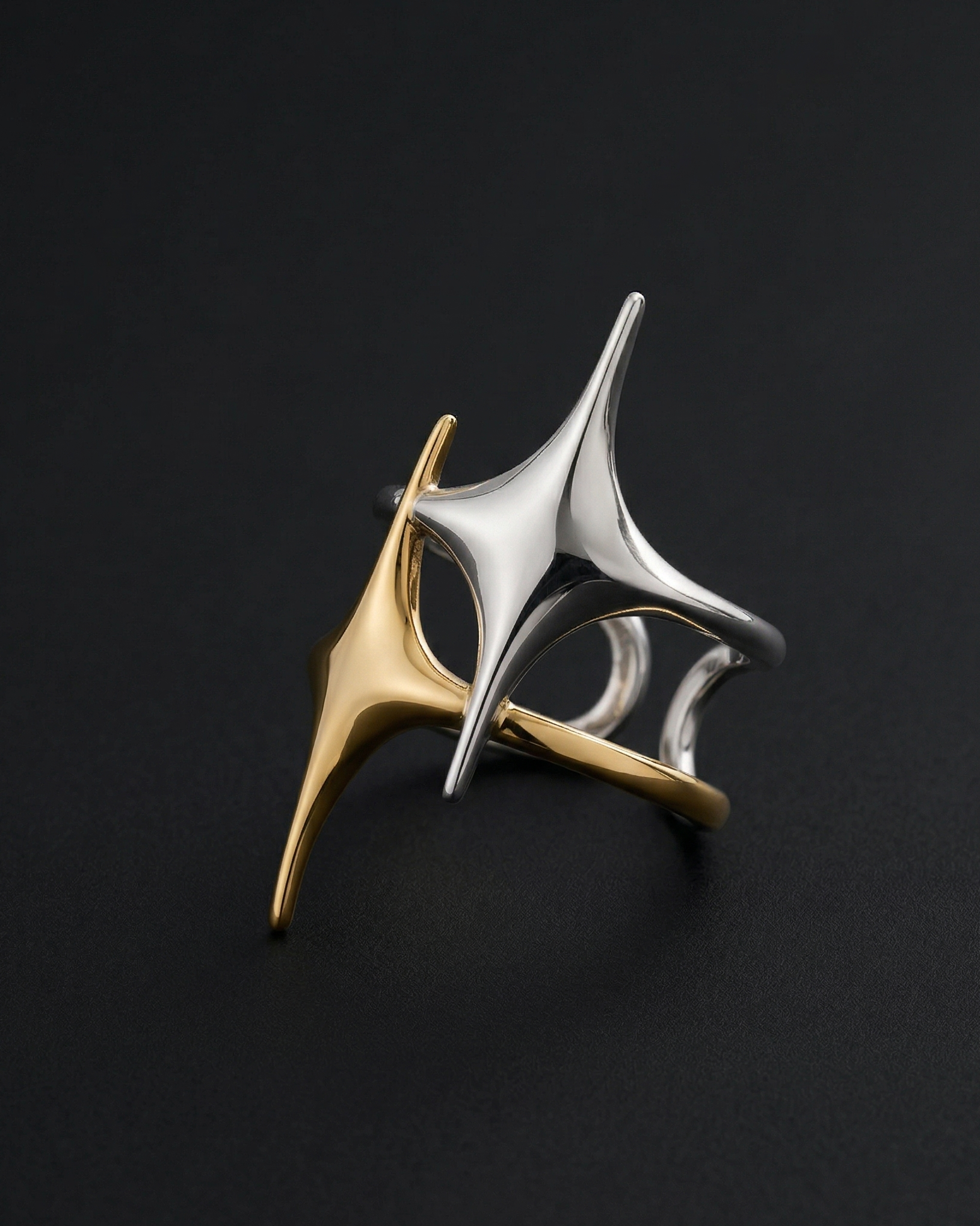 Two metallic rings, one gold and one silver, on a black background.