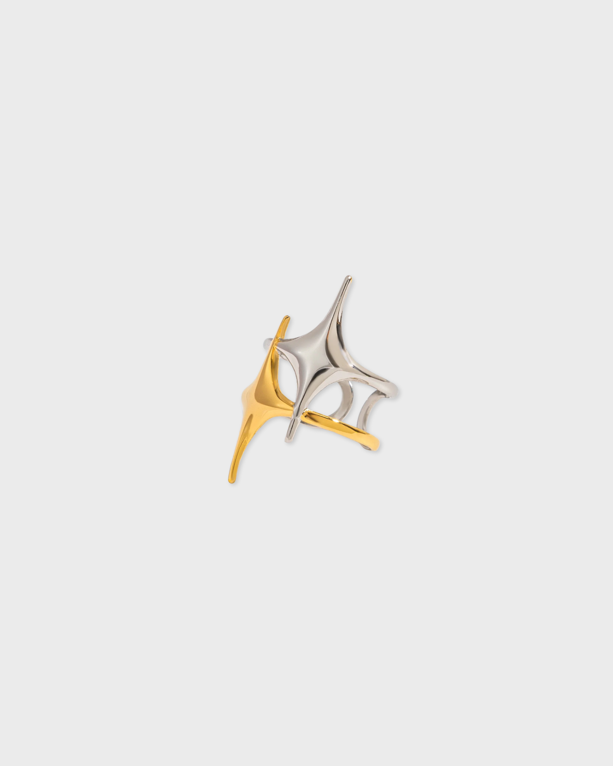 Two gold and silver rings on a light gray background