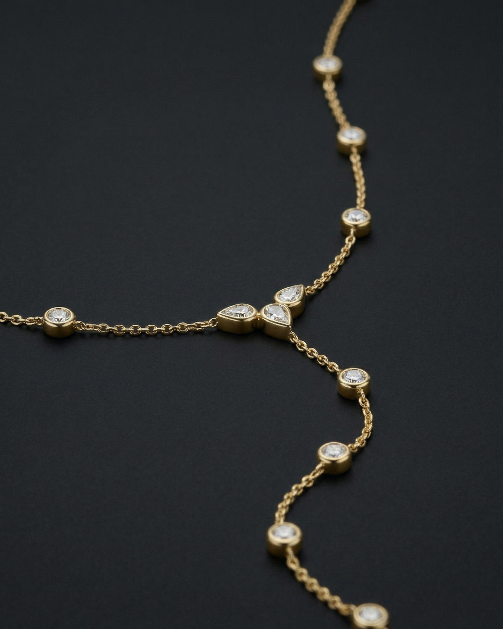 Gold necklace with diamond beads on a black background
