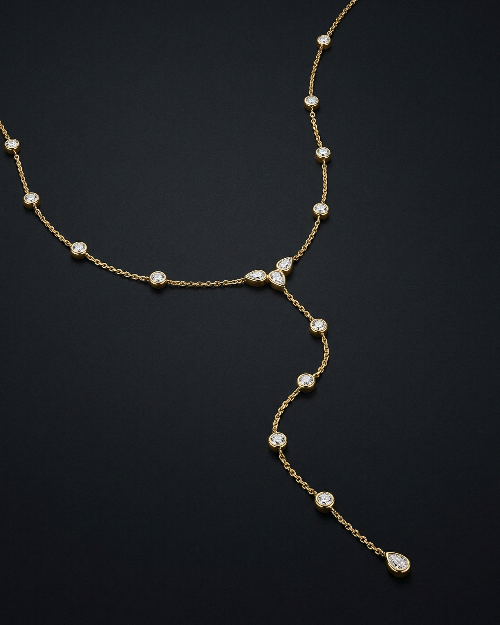 Delicate gold necklace with small pearls on a dark background