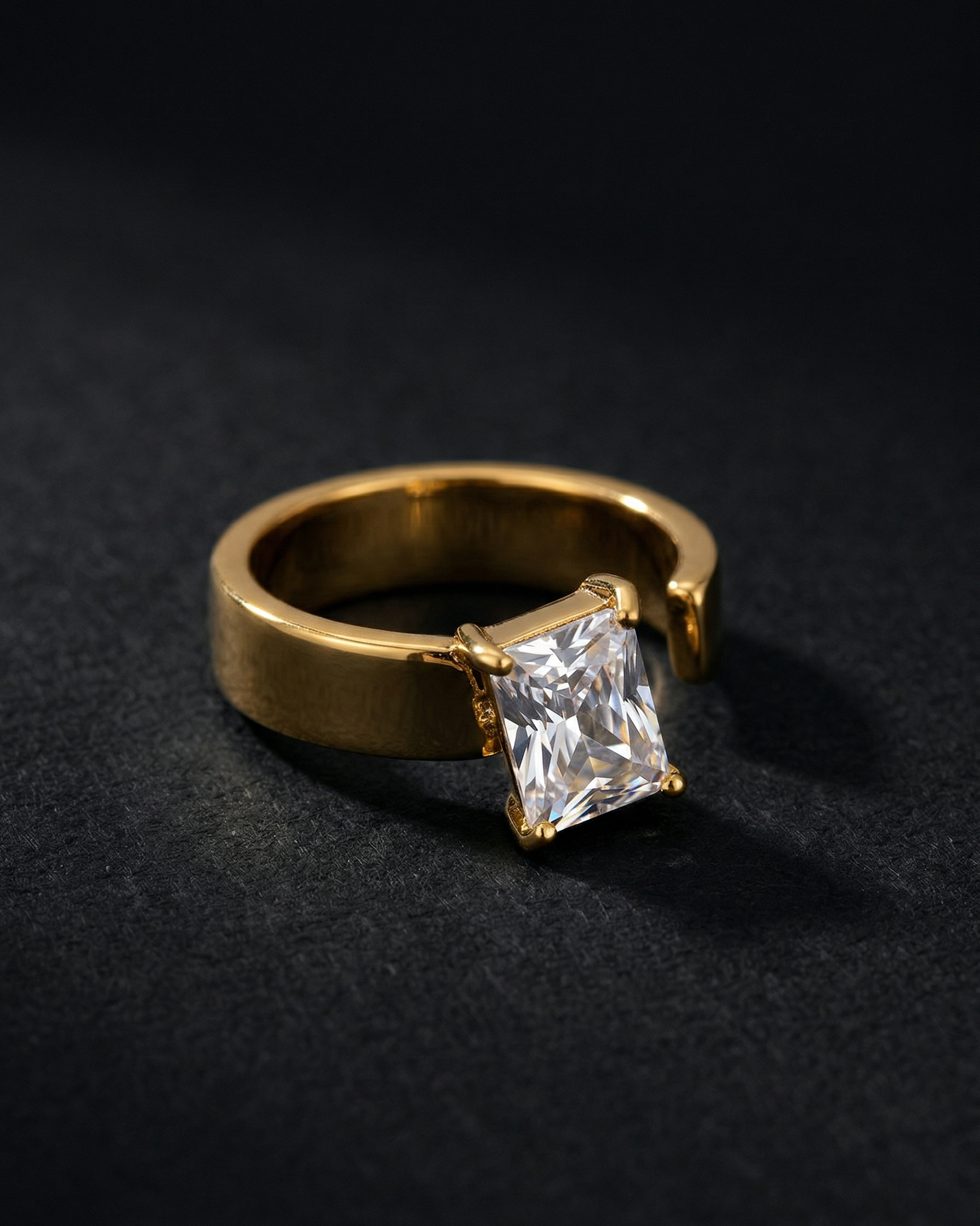 Gold ring with a large diamond on a black background