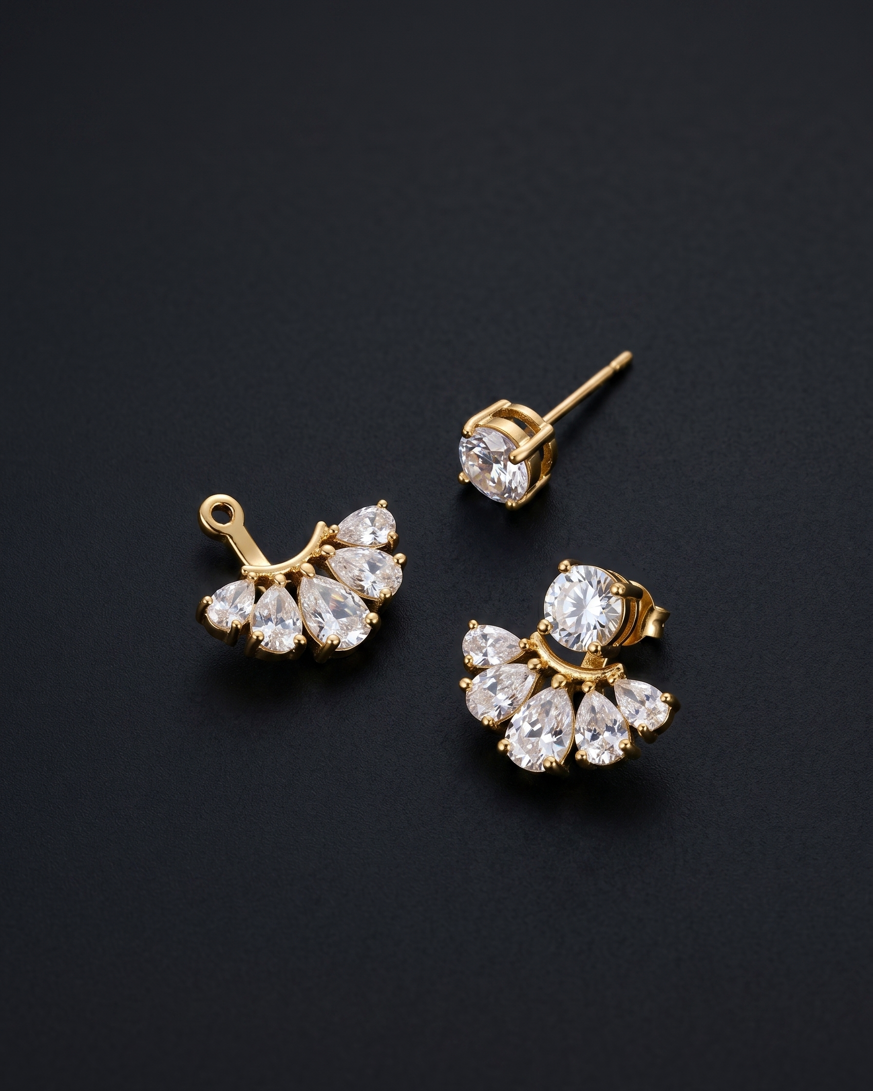 Gold and crystal earrings on a black background