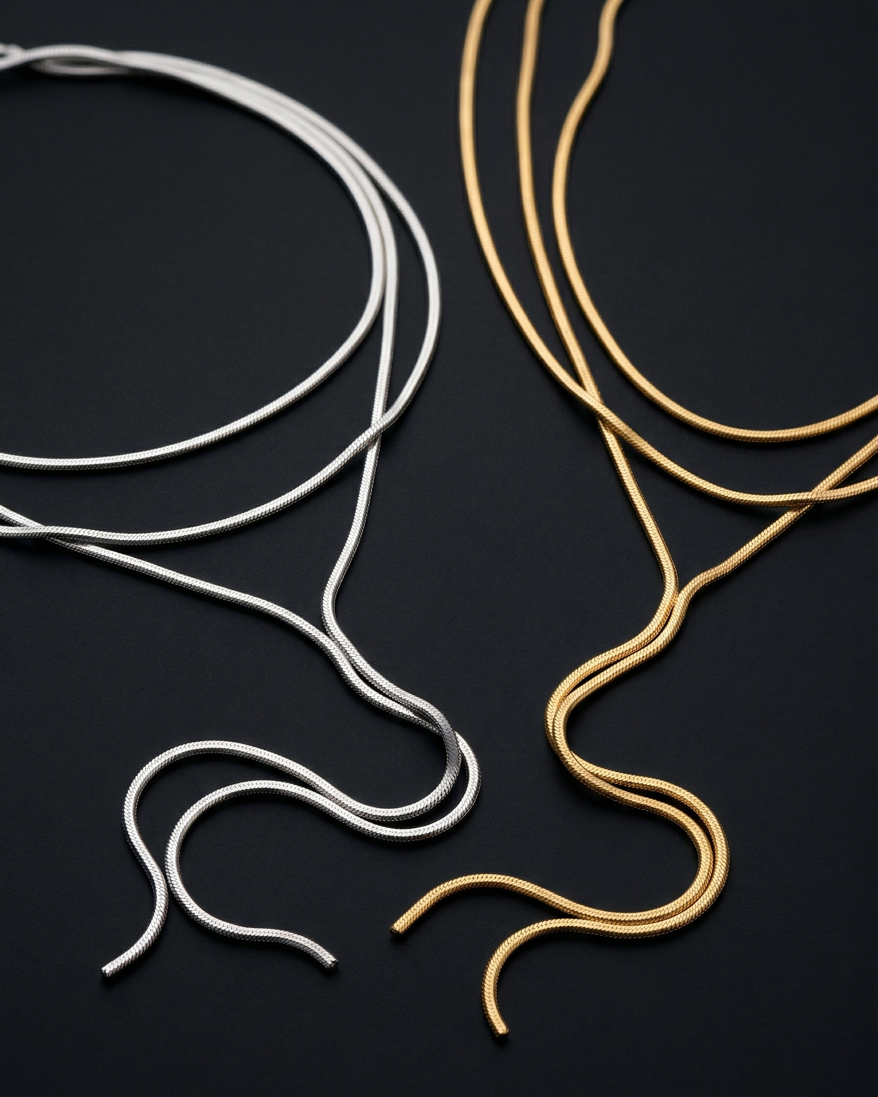 Gold and silver ear wires on a black background